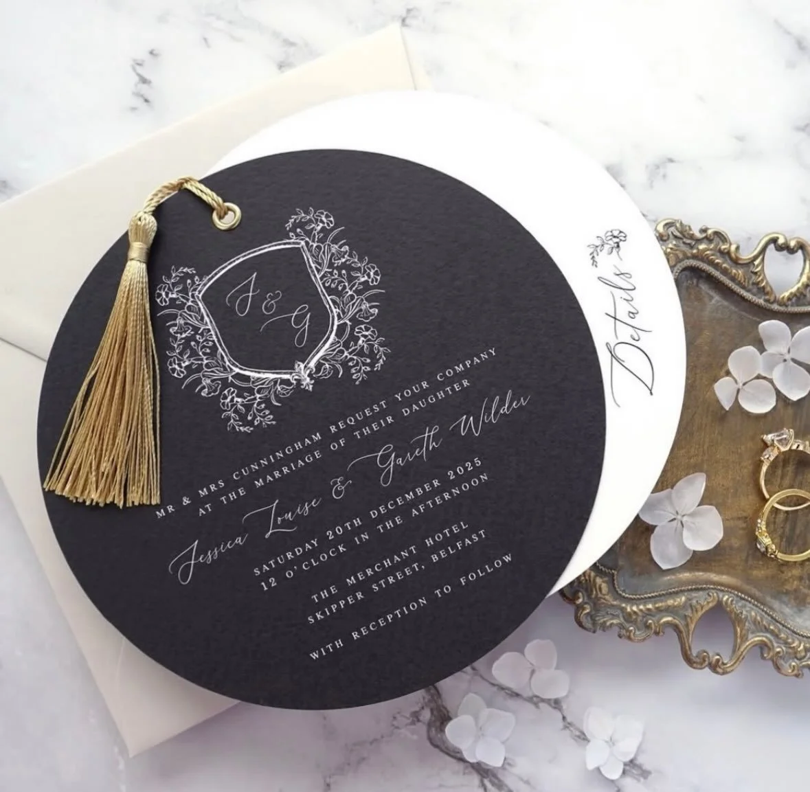 JESSICA - Featuring a circular cut invitation and details card, this design takes luxury to the next level. With a beautiful hand drawn crest, gold eyelet, matching tassel and paired with a premium almond envelope, the Jessica suite certainly makes a