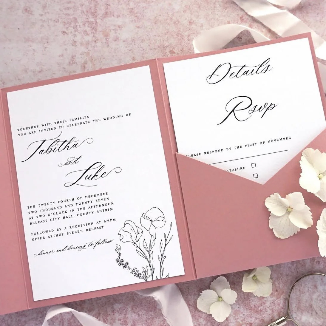TABITHA - Fall in love with this simplistic floral suite. Complete with invitation, details and RSVP cards all held inside a beautiful dusty rose pocketfold, it&rsquo;s perfect for a romantic wedding. Consider adding some organic silk ribbon to keep 