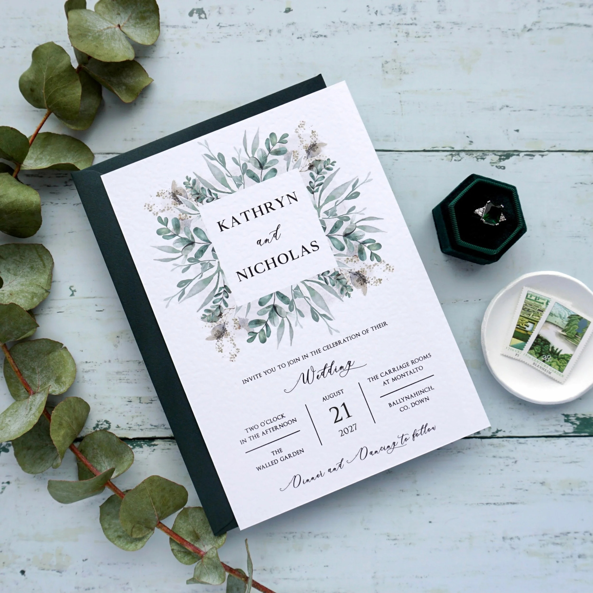 KATHRYN - This stylish suite offers beautiful eucalyptus detailing, printed on hammered cardstock and paired with a luxurious Hunter green envelope. Take these invites to the next level and upgrade to have the names stamped in hot foil... gold foil l