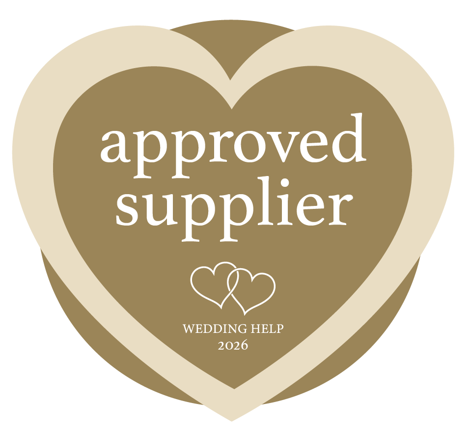 Wedding Help NI Approved Supplier Badge - Beige heart with deep brown circle behind it with text "approved supplier wedding help NI 2026"