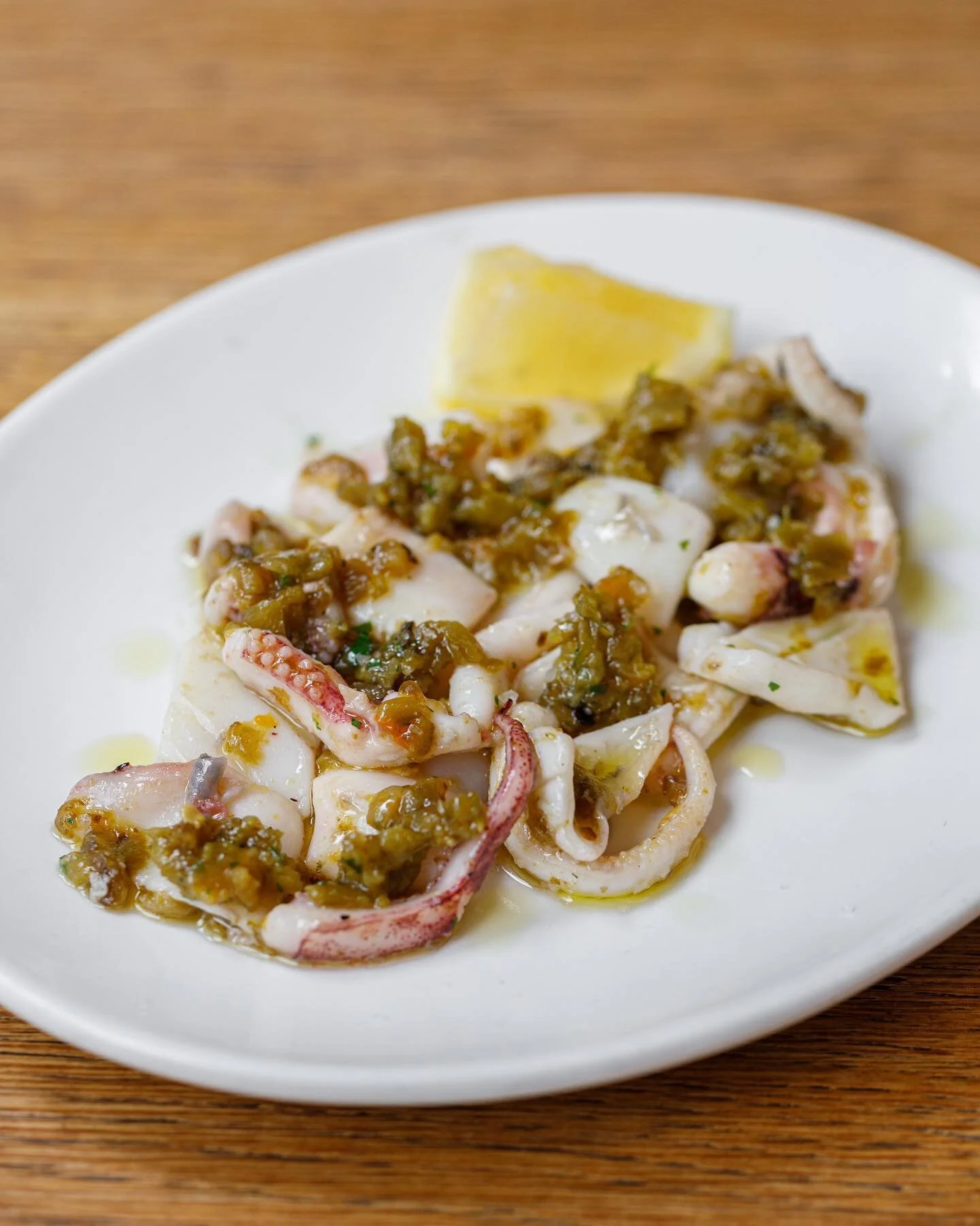 cornish squid, green pepper salsa. 

we use the wings, hoods, throats and tentacles from the @finandflounderwholesale squid, roasting them in the wood oven, until tender. we serve it with a salsa from grilled corno do torro peppers from @flourishprod