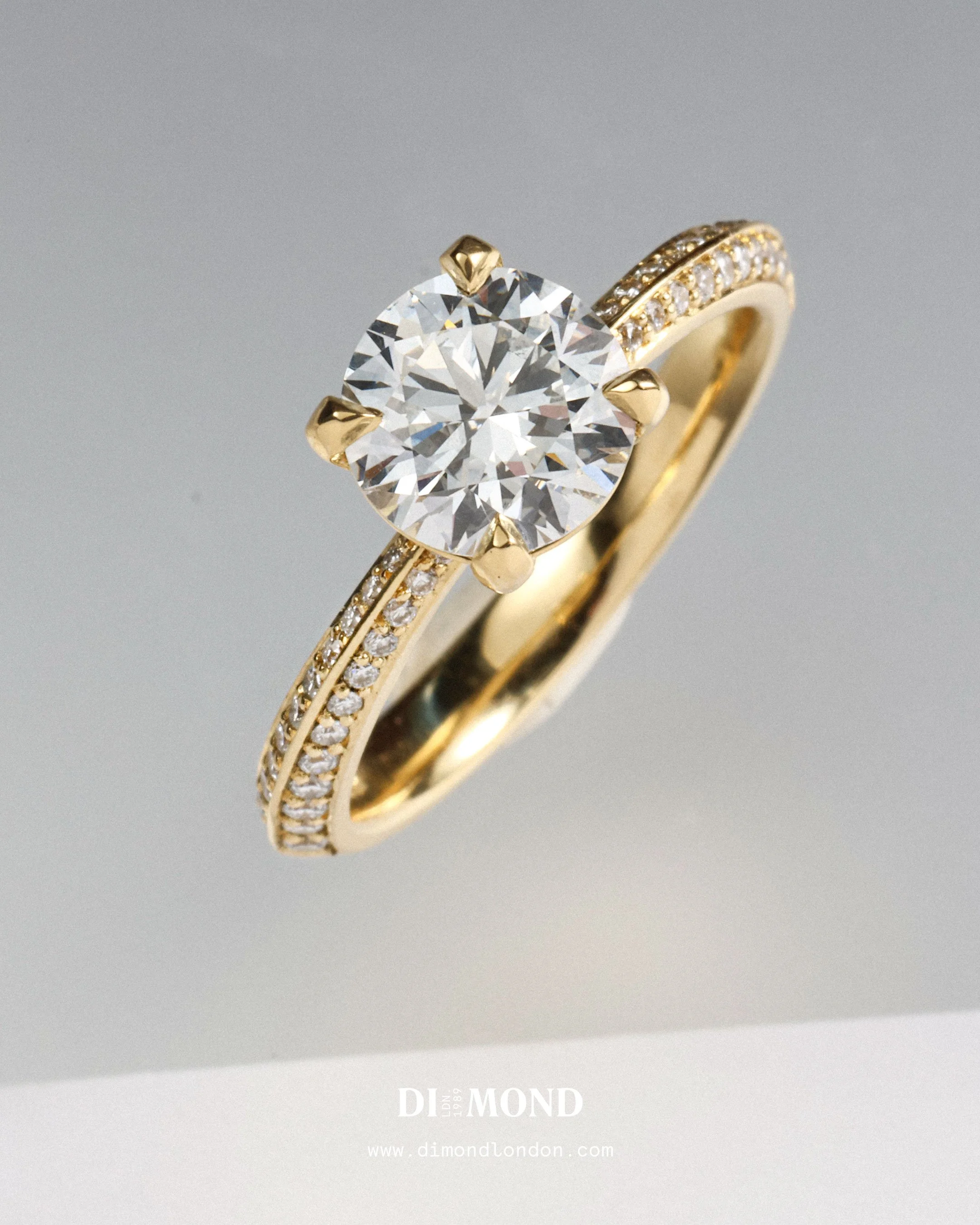 Diamond engagement ring with gold band and side stones.