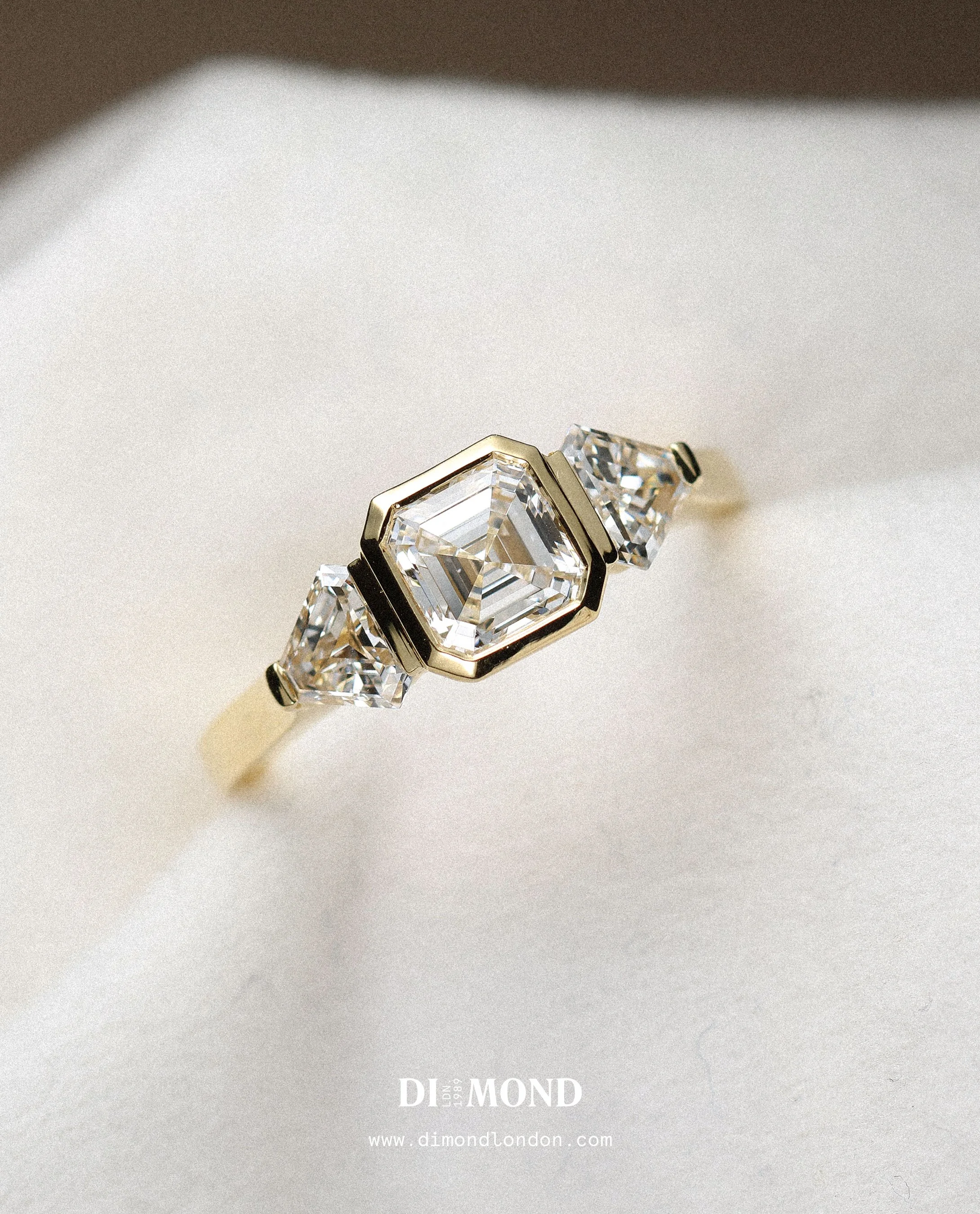 Art Deco bezel set trilogy engagement ring.
