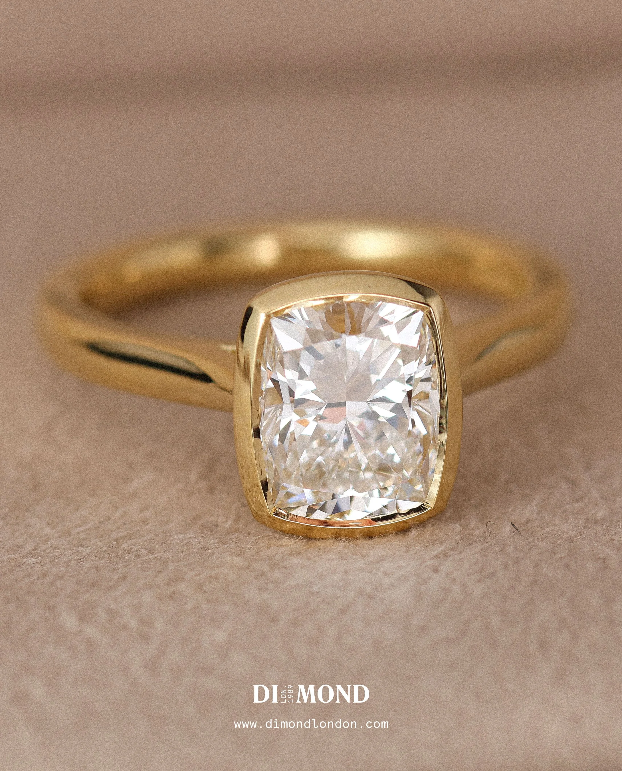 Large cushion cut diamond with gold bezel setting