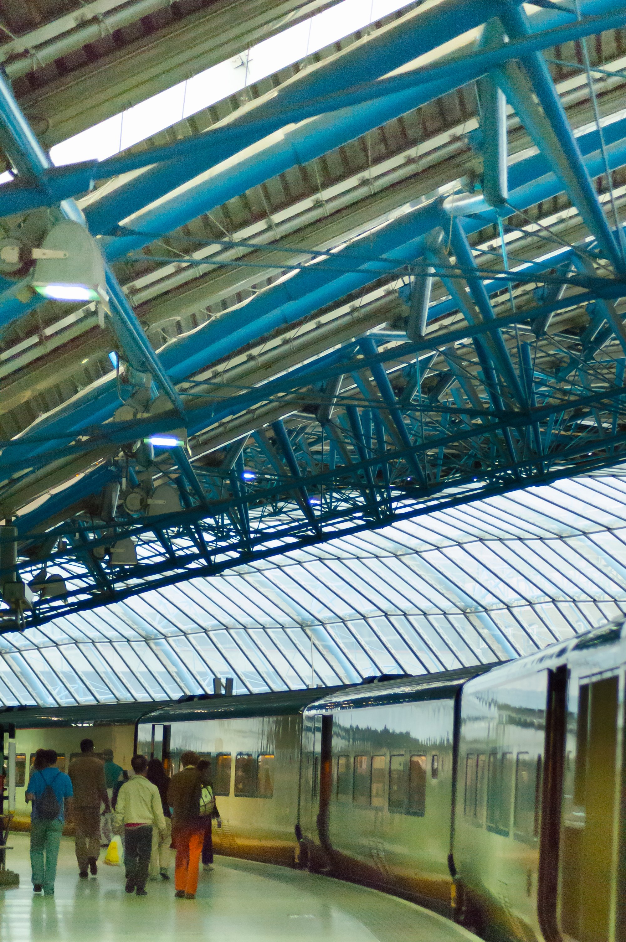 people walking to train in train station