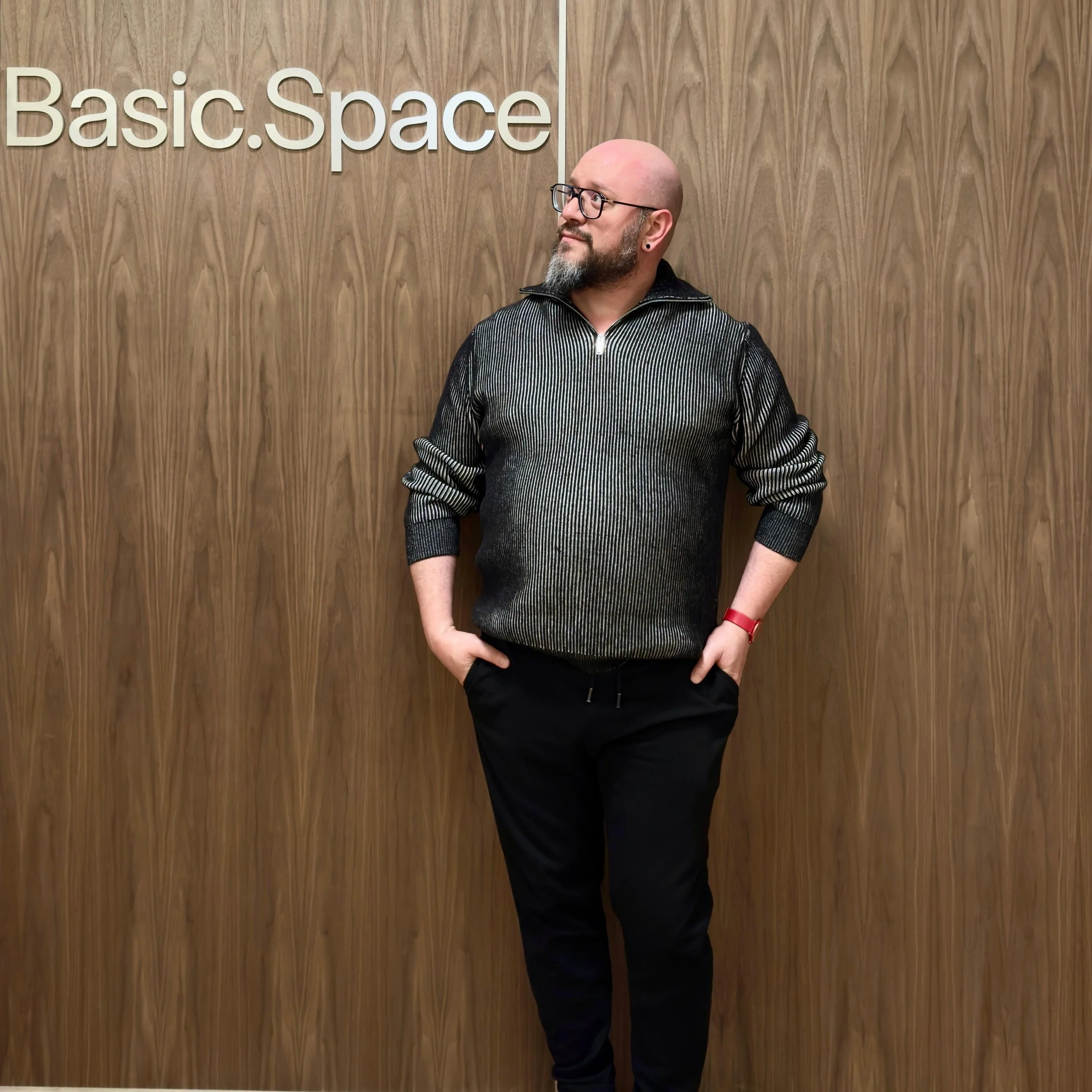 A photo of Yudi Kaufman standing in front of Basic.Space sign