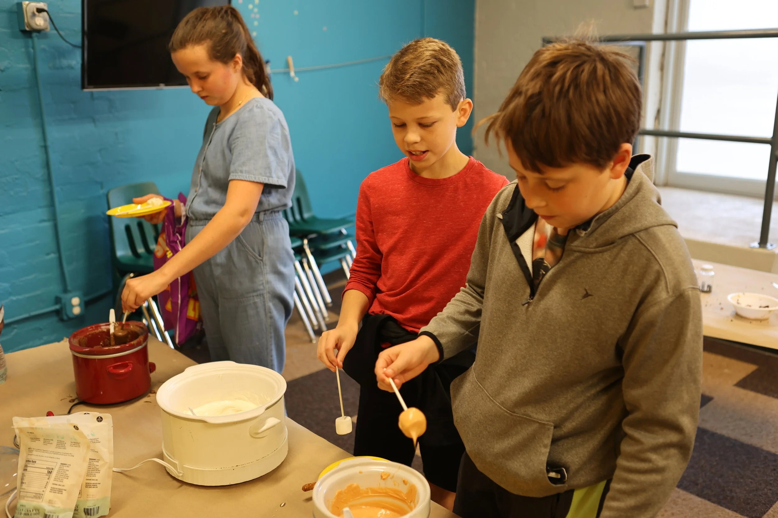 Busby and Mikie dipping marshmallows.jpg