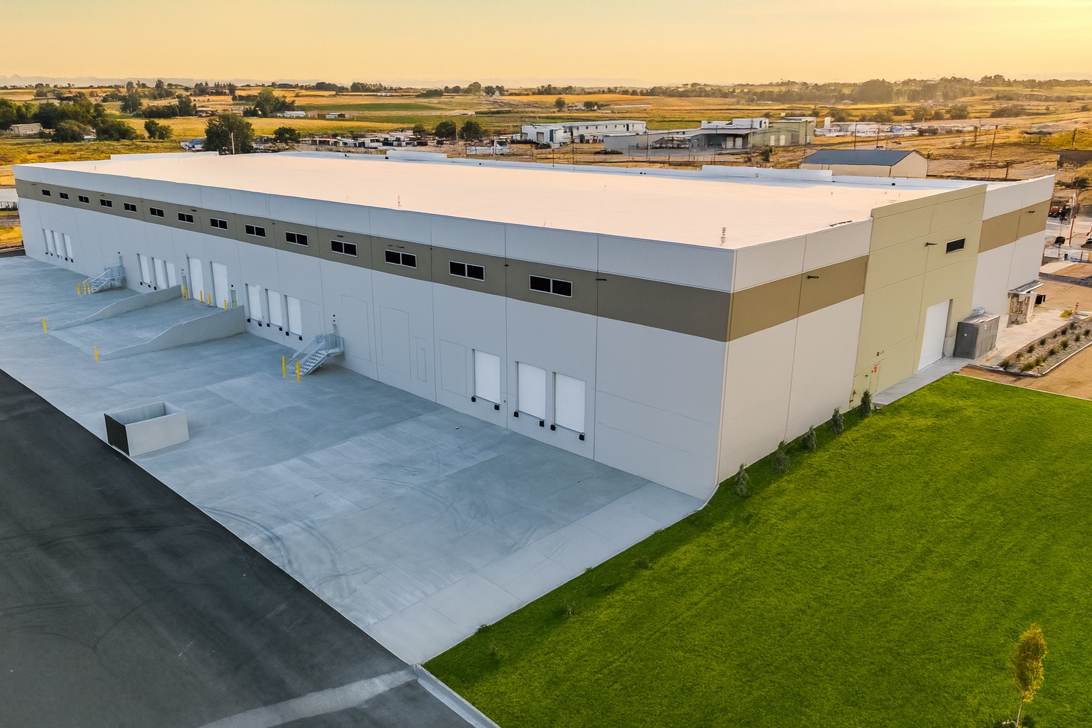 Warehouse at Sunset Over Fields.png