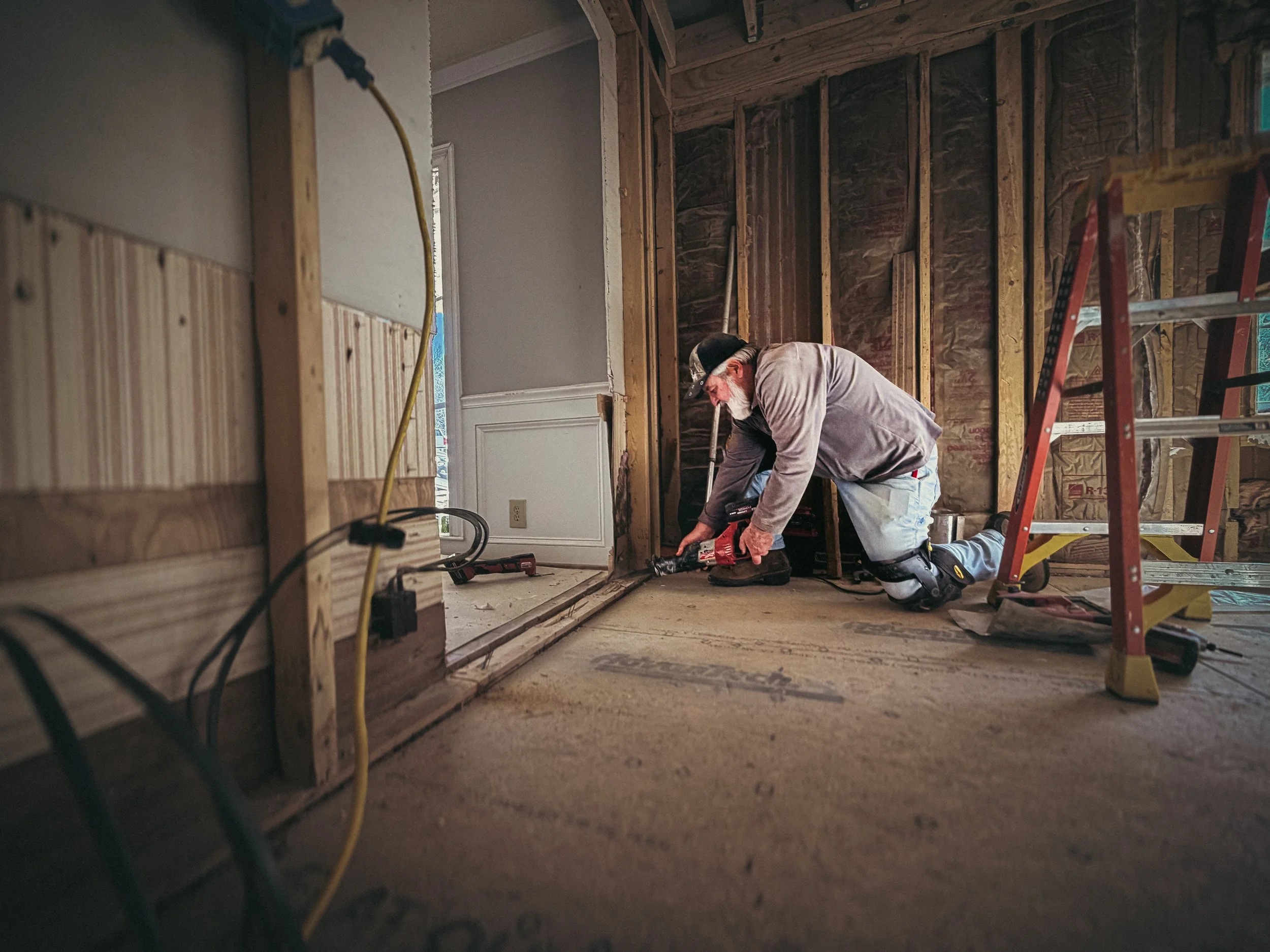 Athens, GA framing contractor repairing subflooring and wall studs in a residential home renovation project.