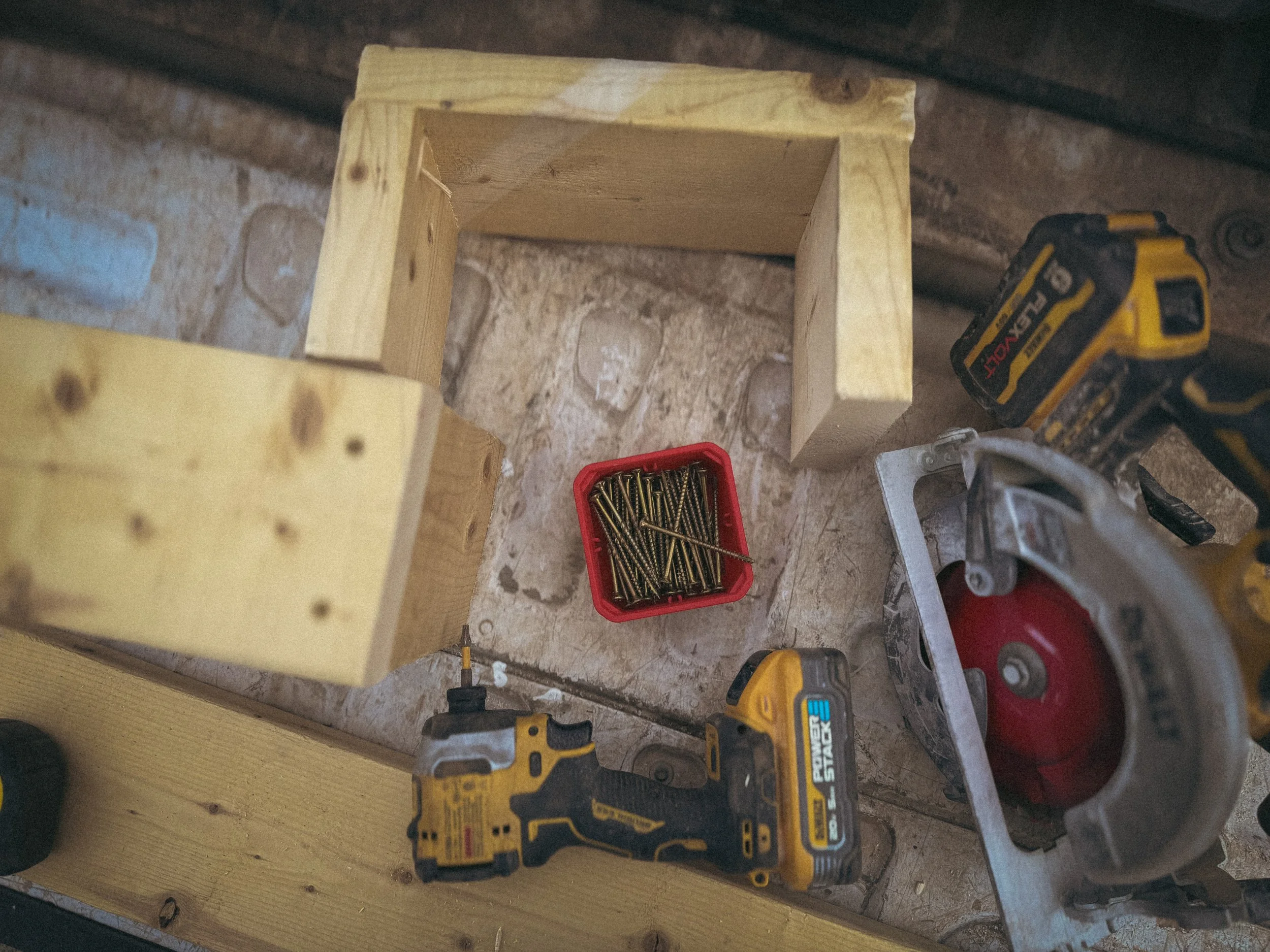 Top-down view of handyman tools and GRK multipurpose screws on wood during commercial maintenance work in Athens, GA.