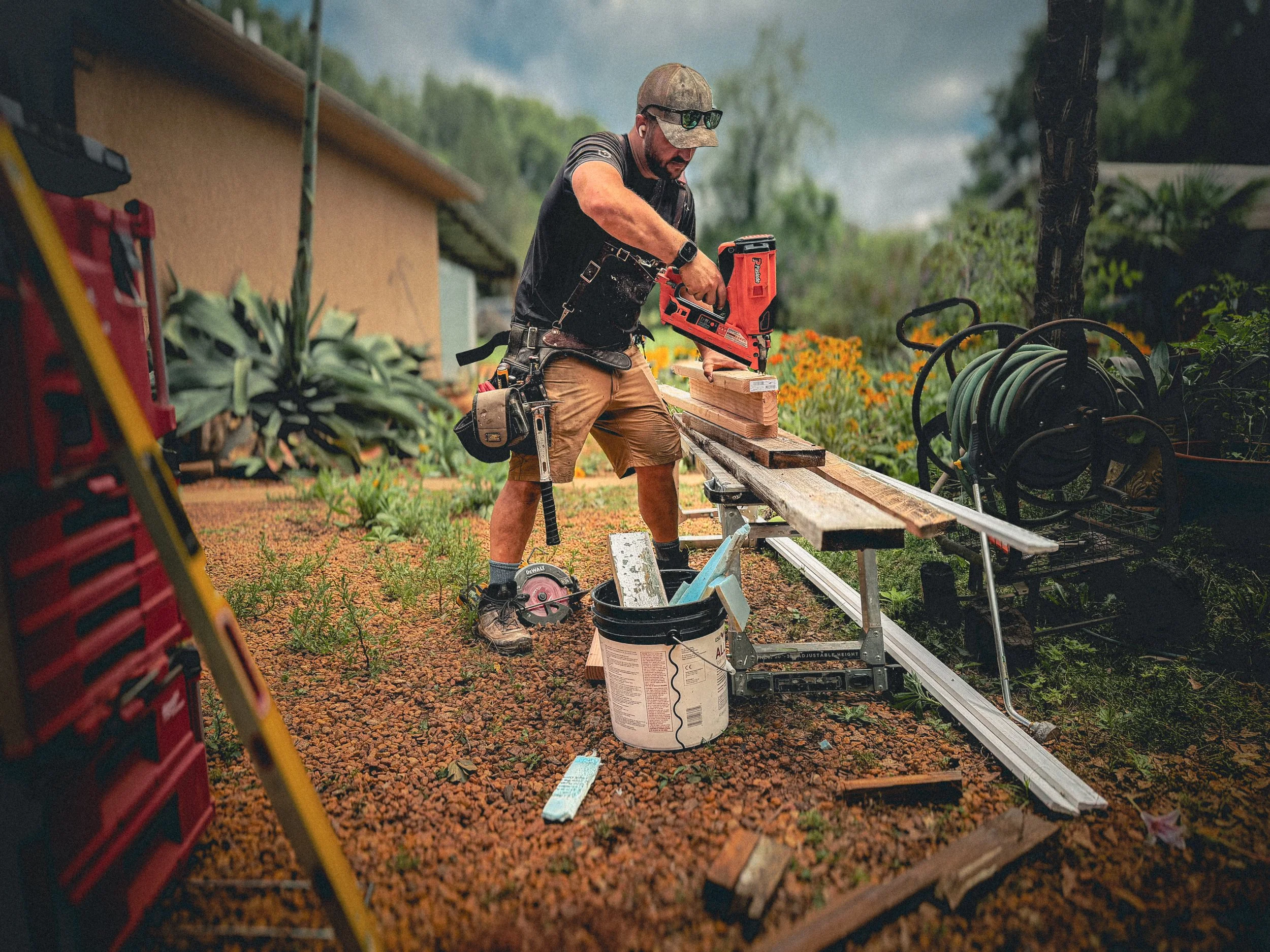 Carpenter using a framing nailer to assemble lumber for a home repair in Athens, GA