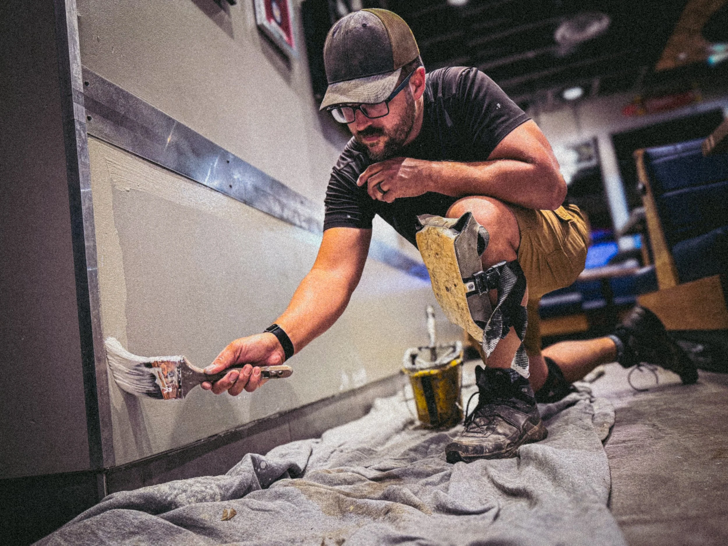 Interior and exterior painting. Sprayer applying exterior topcoat paint.