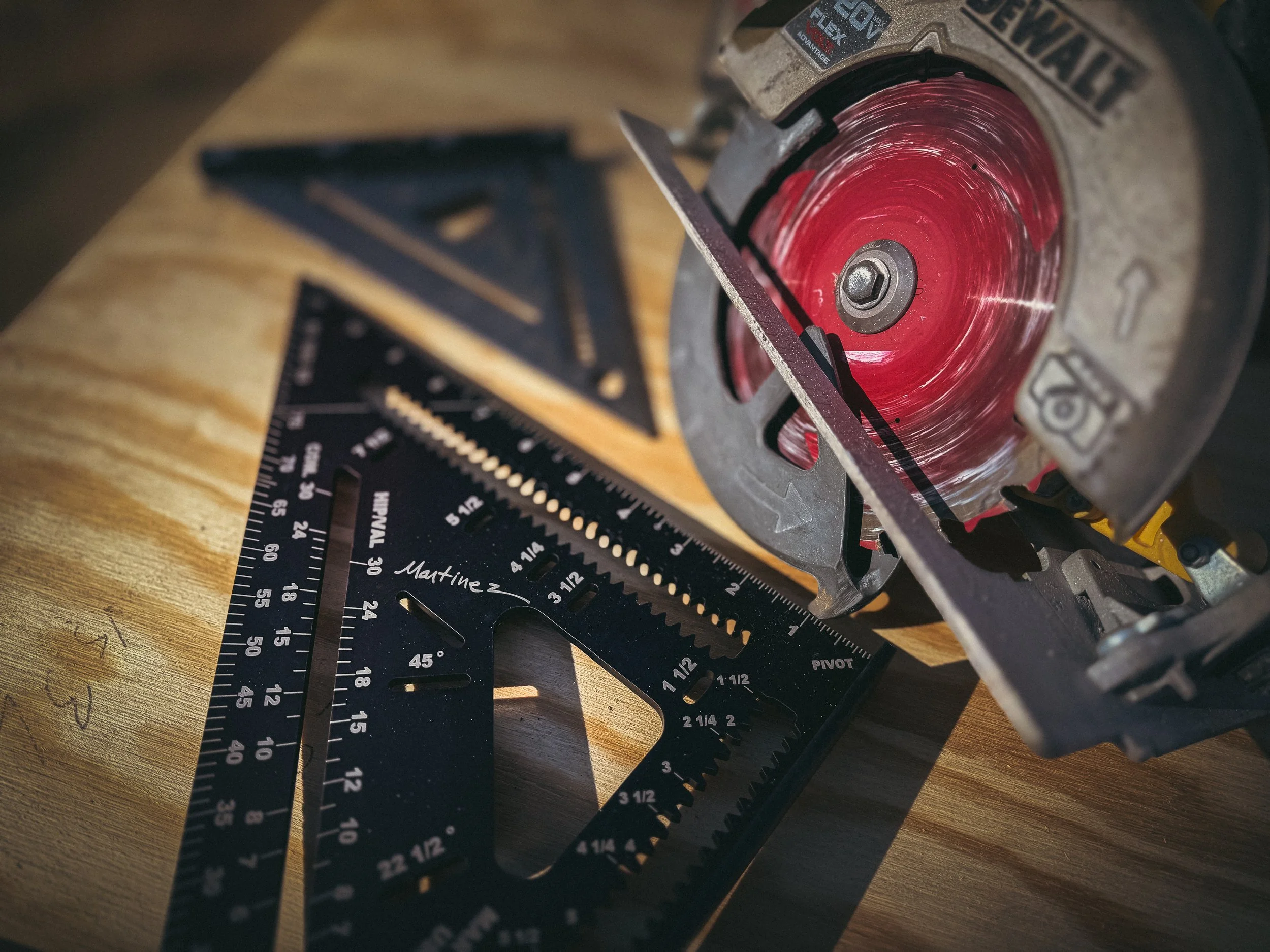 Close-up of a Martinez 12-inch speed square and DeWalt circular saw on a residential job site in Athens, Georgia. Why