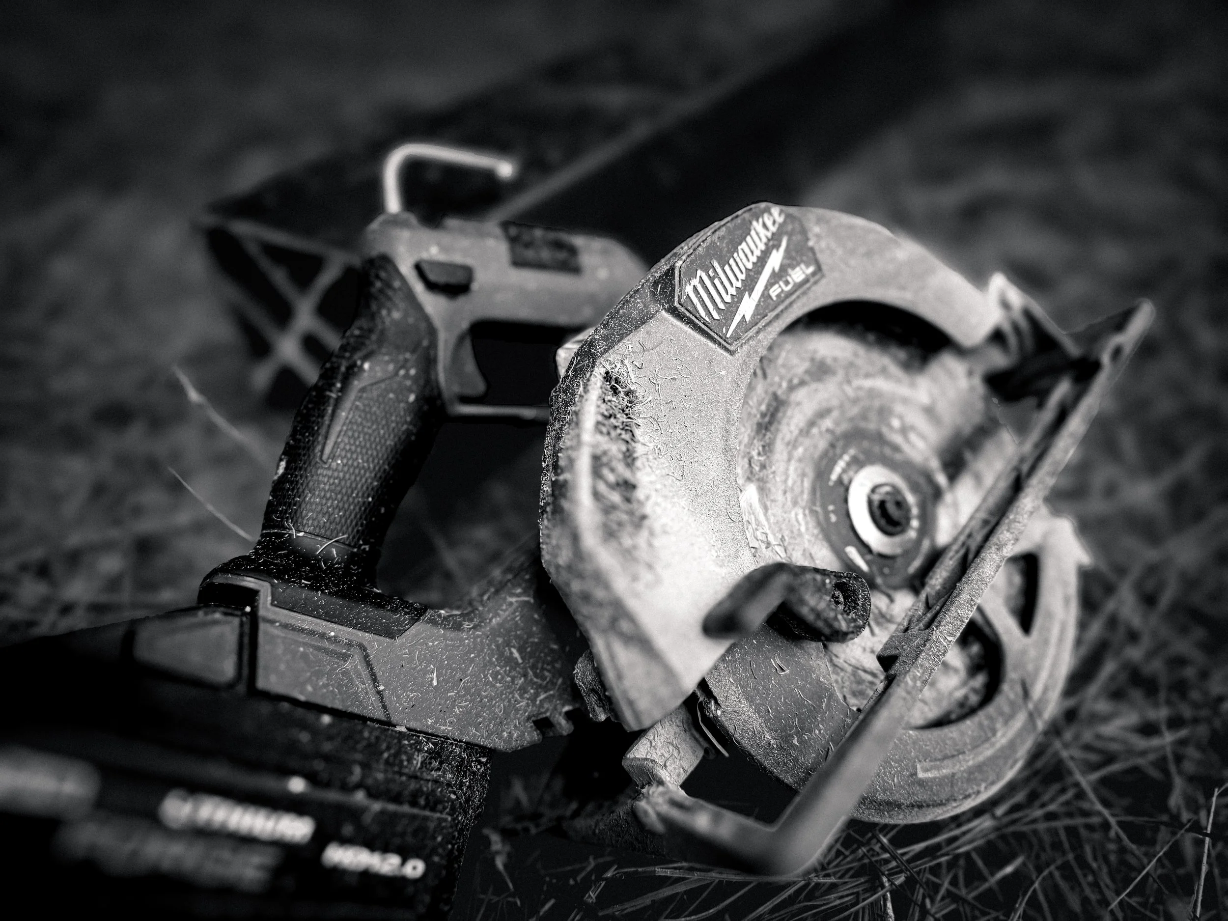 Close up image of a milwaukee circular saw in black and white