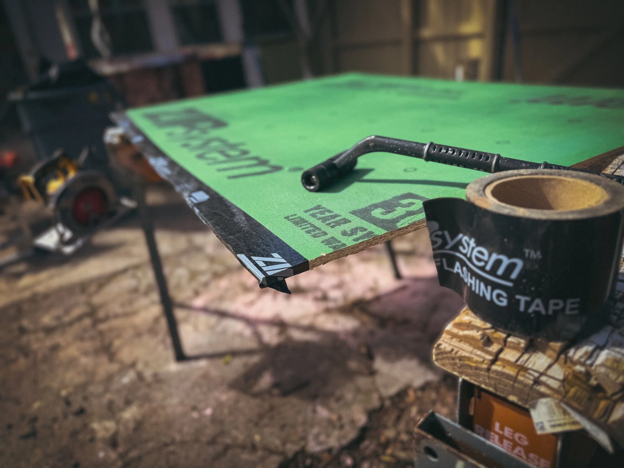 Professional framing contractor in Athens, GA, preparing Huber Zip System sheathing with integrated flashing tape for a moisture-resistant build.