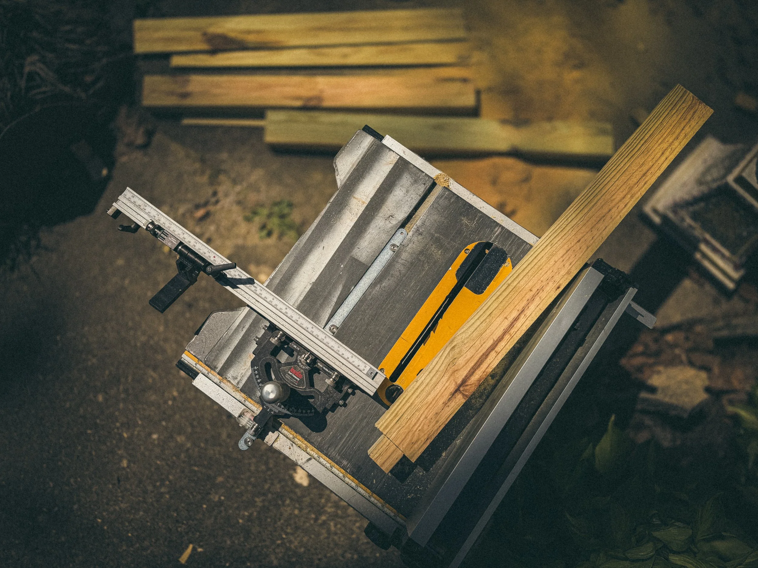 A birds eye view of jobsite tablesaw with a mitre guage used to create a tenon on the repair handrail for an Athens, GA project