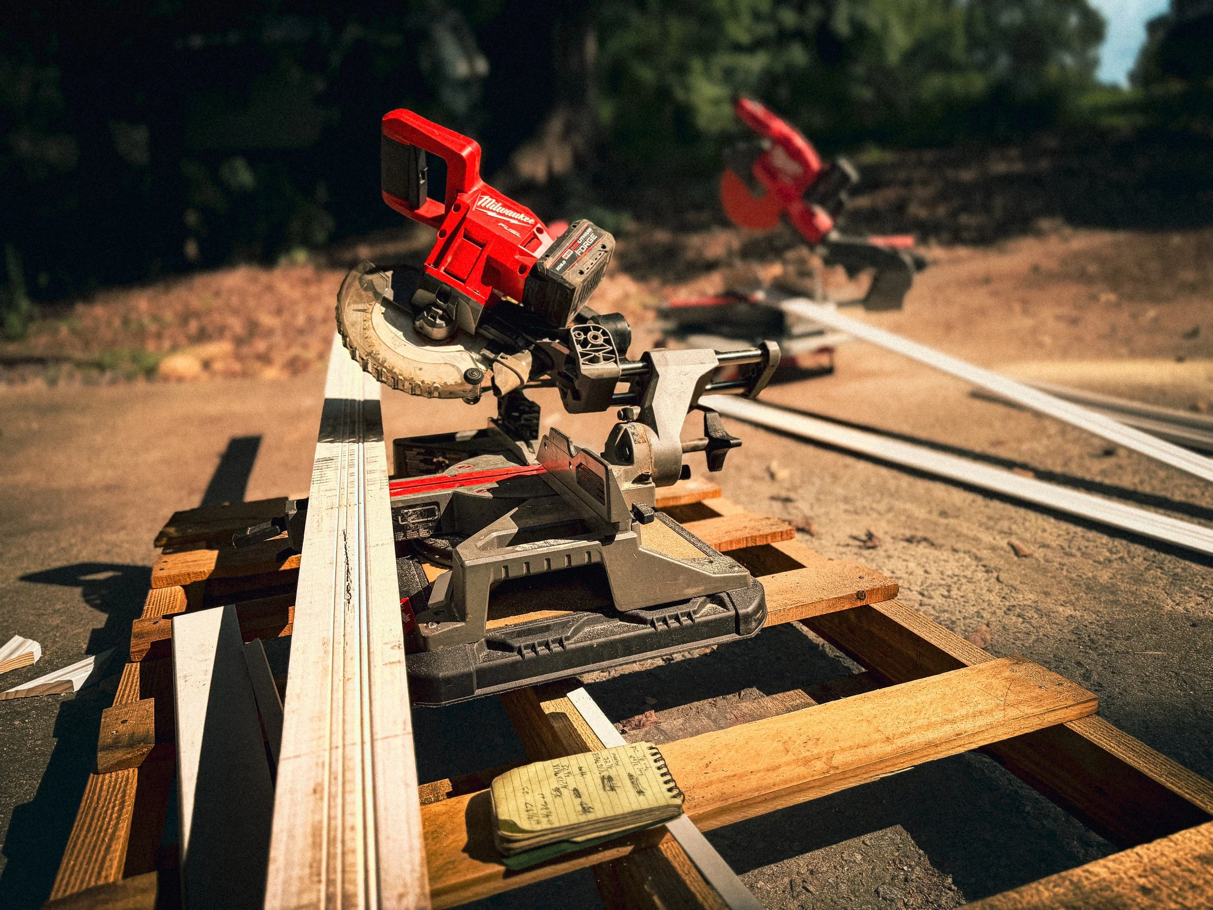 Two milwaukee mitresaws set up to allow multiple carpenters to work quick