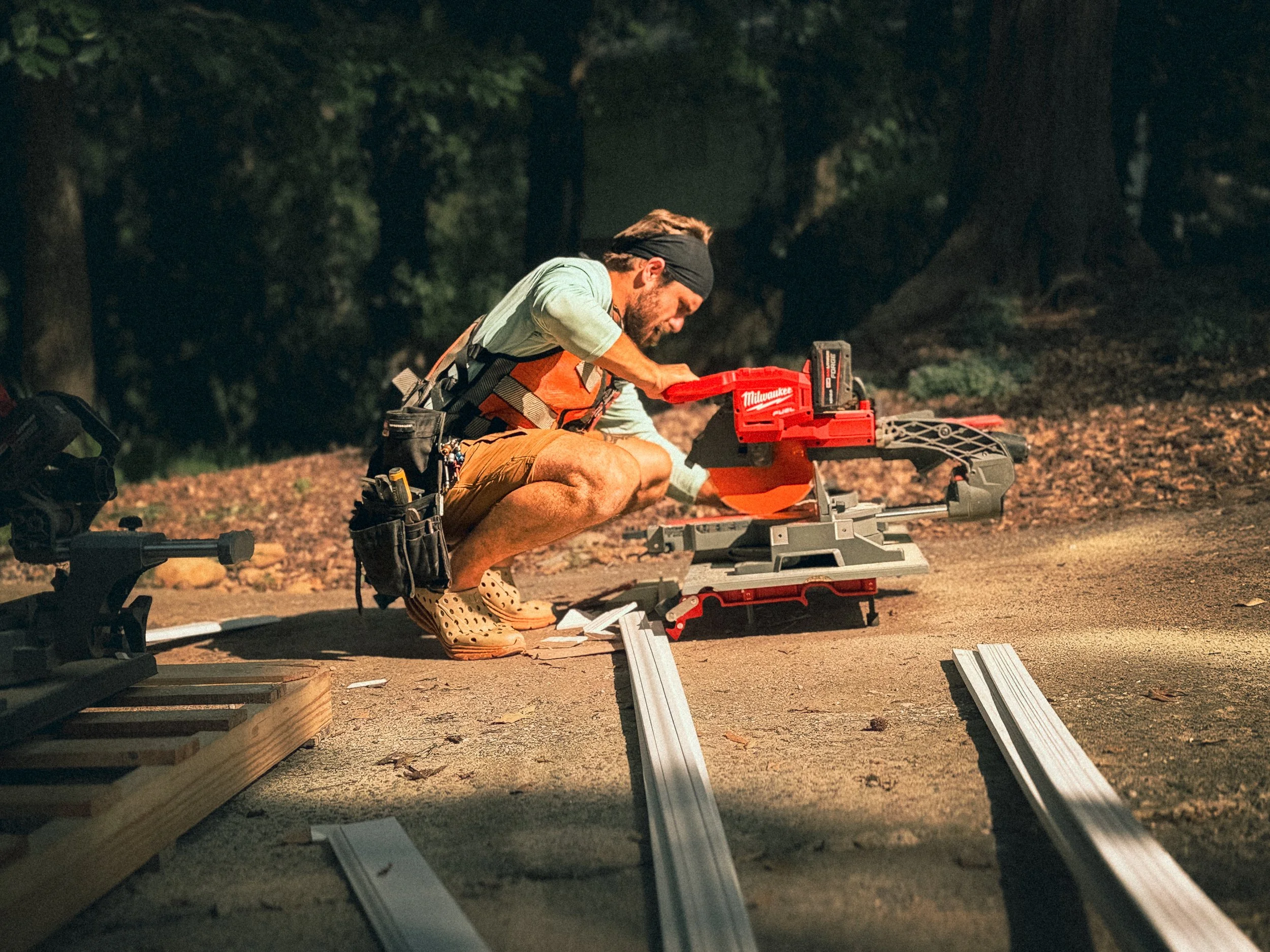Carpenter using a mitre saw to cut trim for a bathroom remodel in Athens, GA