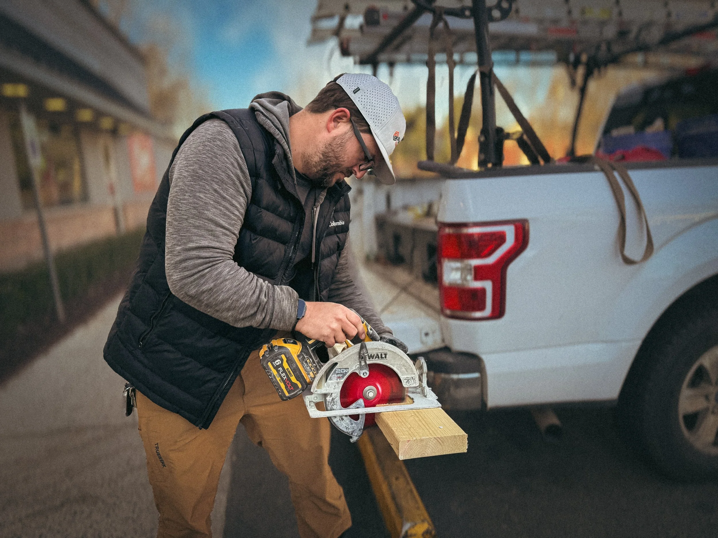 Commercial Handyman in Athens, GA using a circular saw to cut a 2x6 board for a quick-service restaurant facility maintenance project.