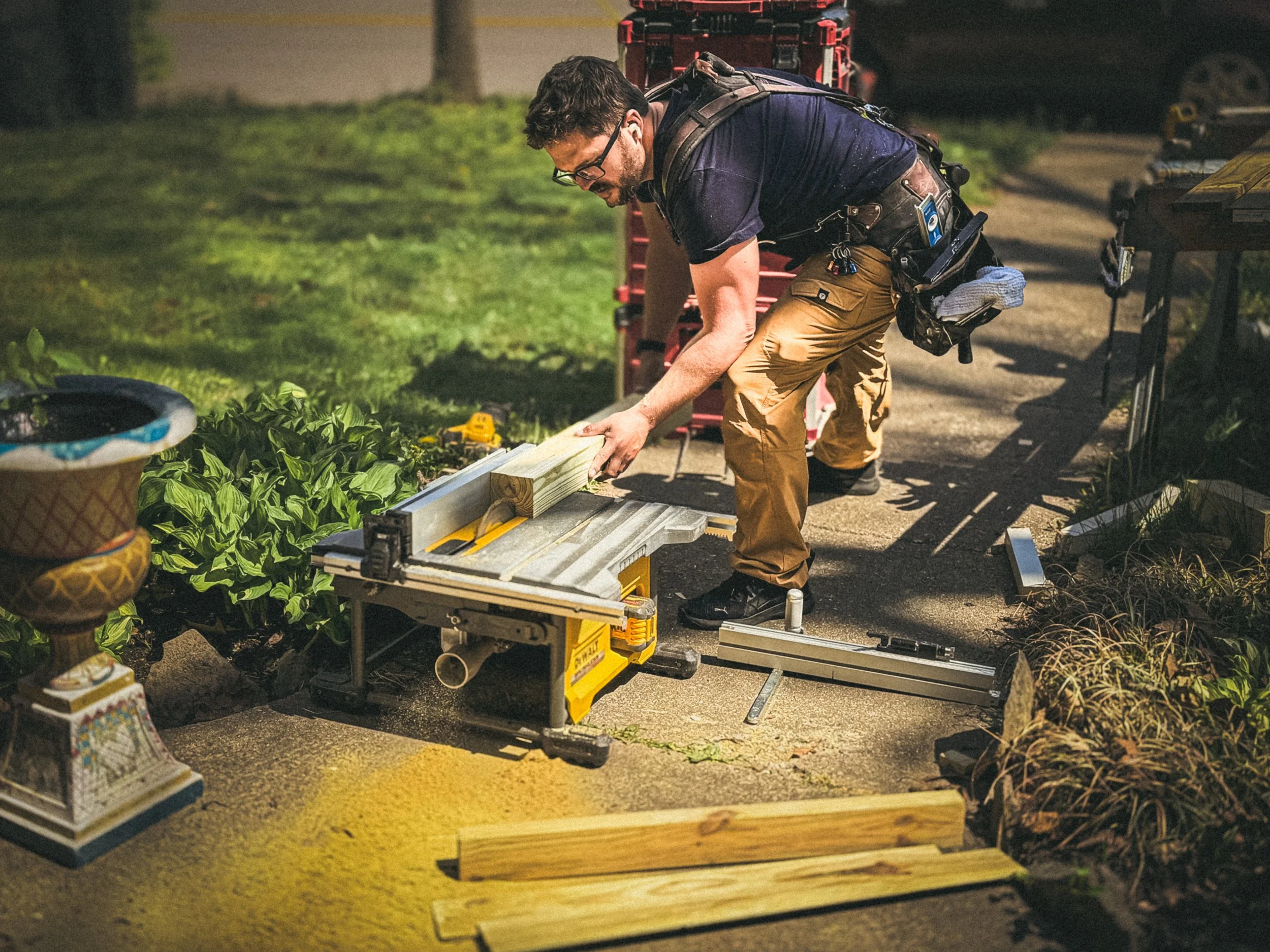 Carpenter milling down wood on a tablesaw to repair a historical handrail in Athens, GA