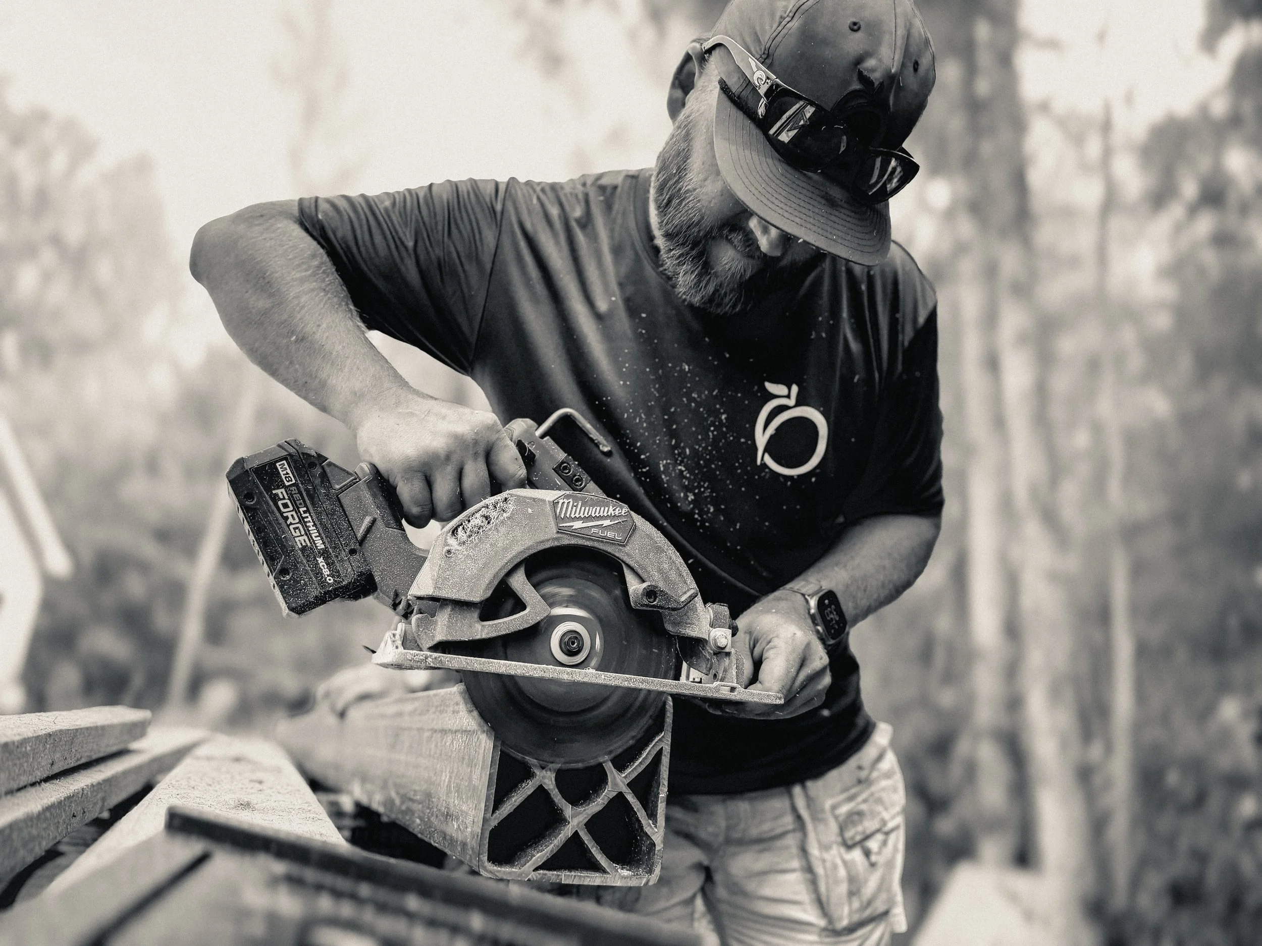 Athens, GA carpenter using a milwaukee circular saw to square the base of an OC Lumber post