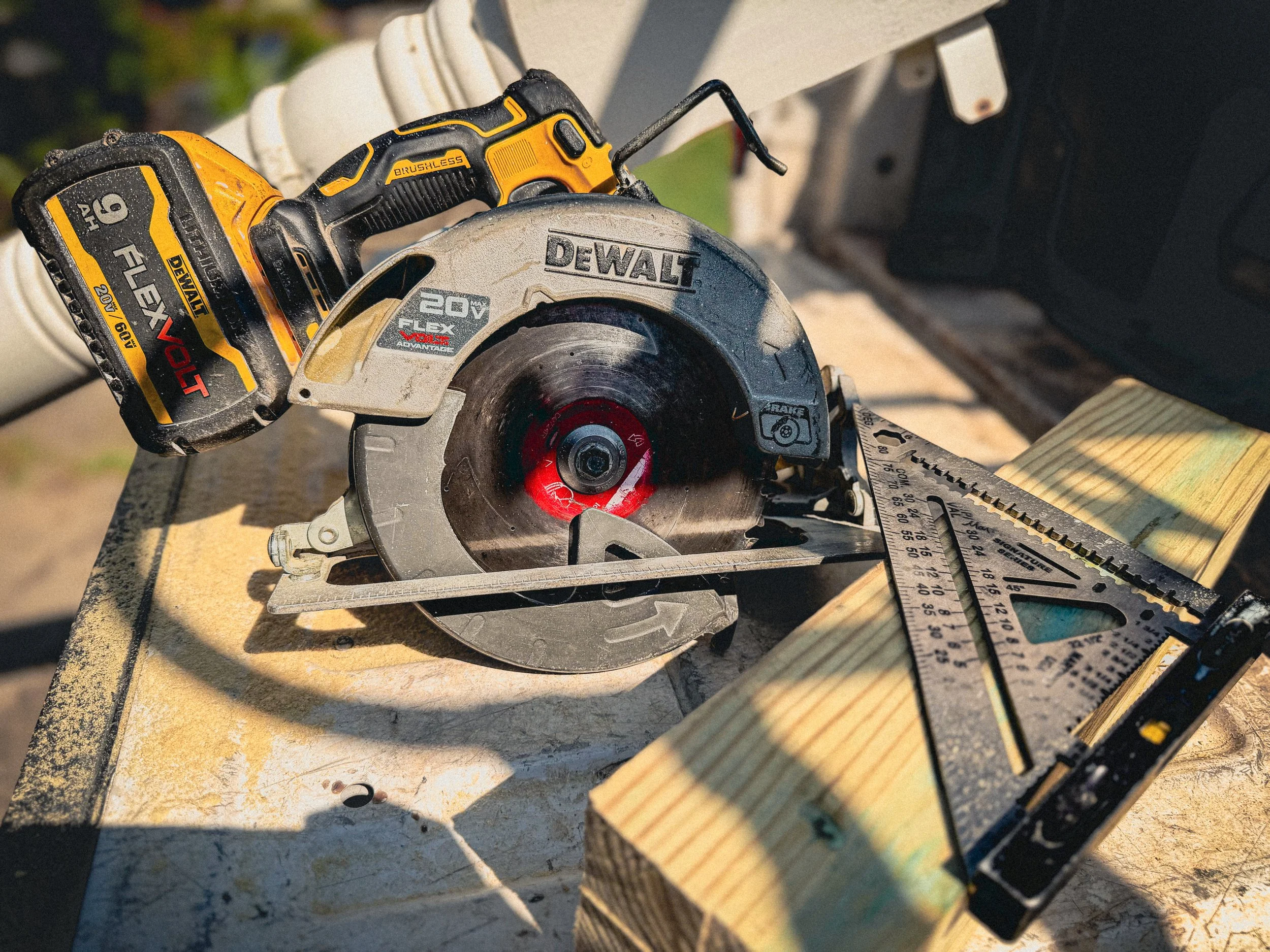 A Dewalt circular saw sitting next to a Martinez speed square