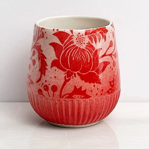 Slip cast cup, decorated with the red Kalamkari underglaze transfer, then sprayed with @amacobrent&rsquo;s red Sprayz.