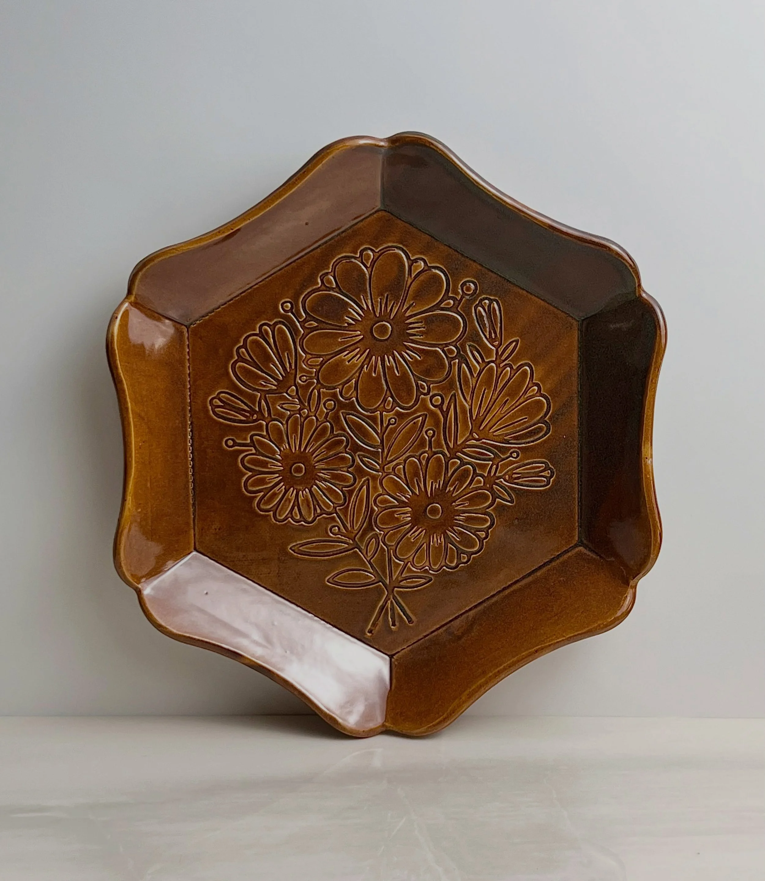 What a difference a glaze makes. The first plate - a glaze called &ldquo;Ocean&rdquo; that I made, and the 2nd is Mayco&rsquo;s &ldquo;Amber Topaz&rdquo;. The stencil is one of mine called &ldquo;Flower Bouquet&rdquo;, and the rim template is the &ld