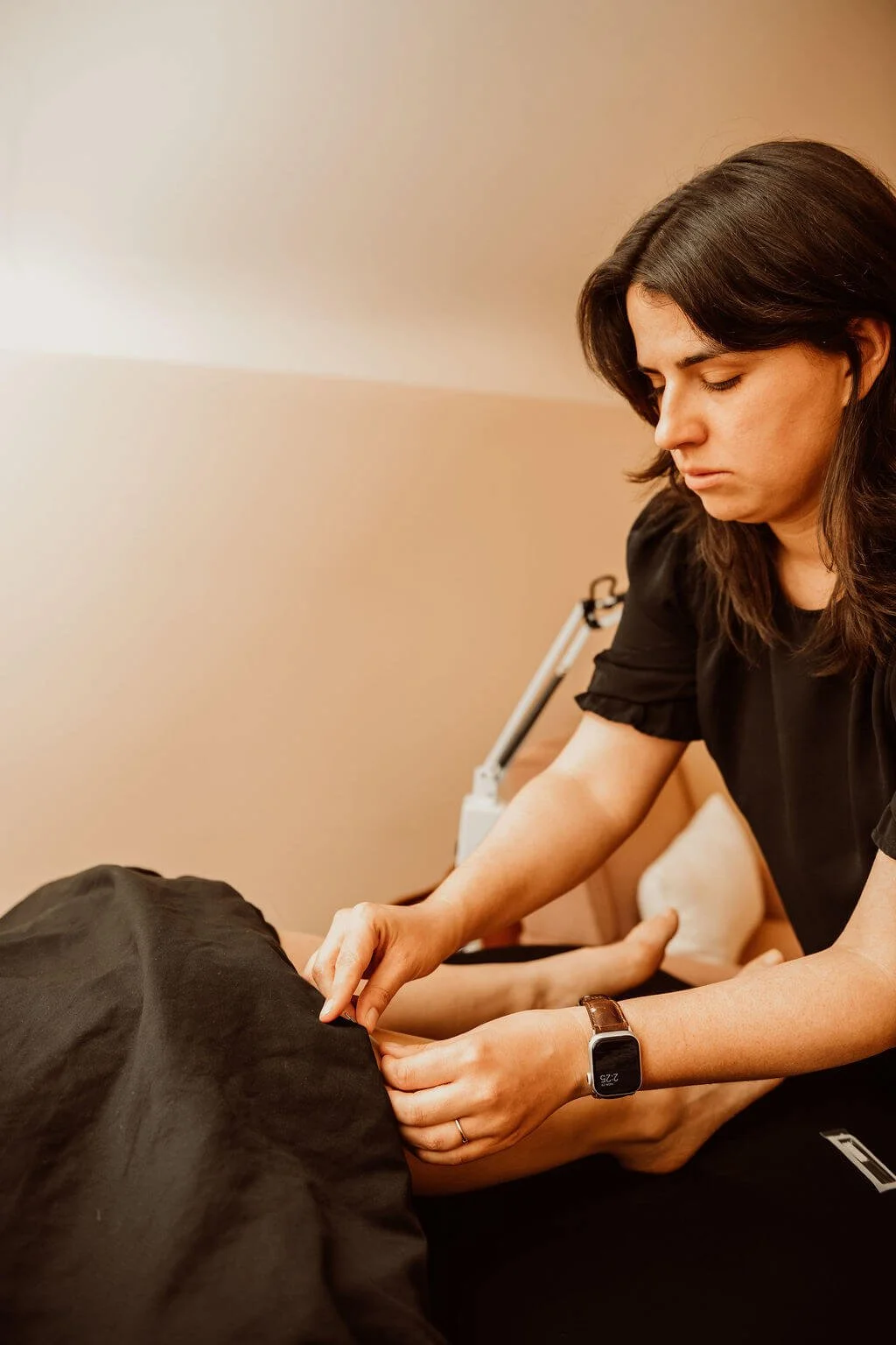 Micaela treating postpartum client with acupuncture in Doylestown, Bucks County PA
