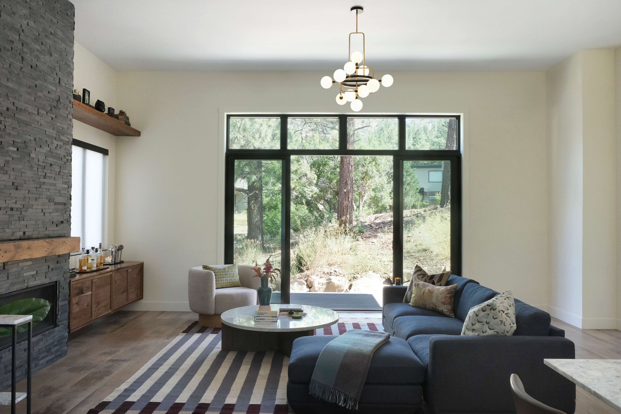 Dorothy Parker Durango Interior Design Blue sofa living room and contemporary chandelier.jpg