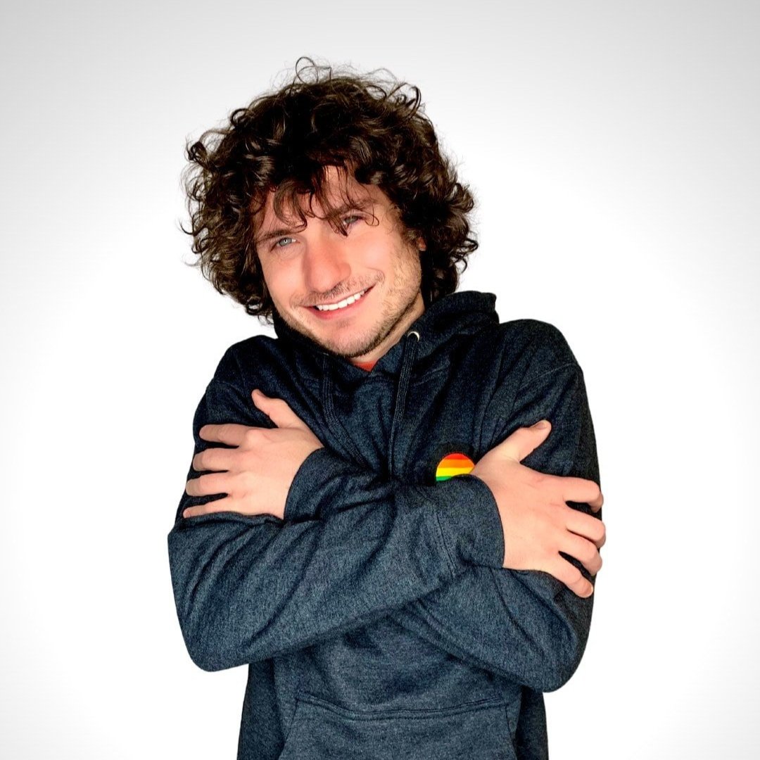 Photo of a man smiling wearing a Source branded hoodie