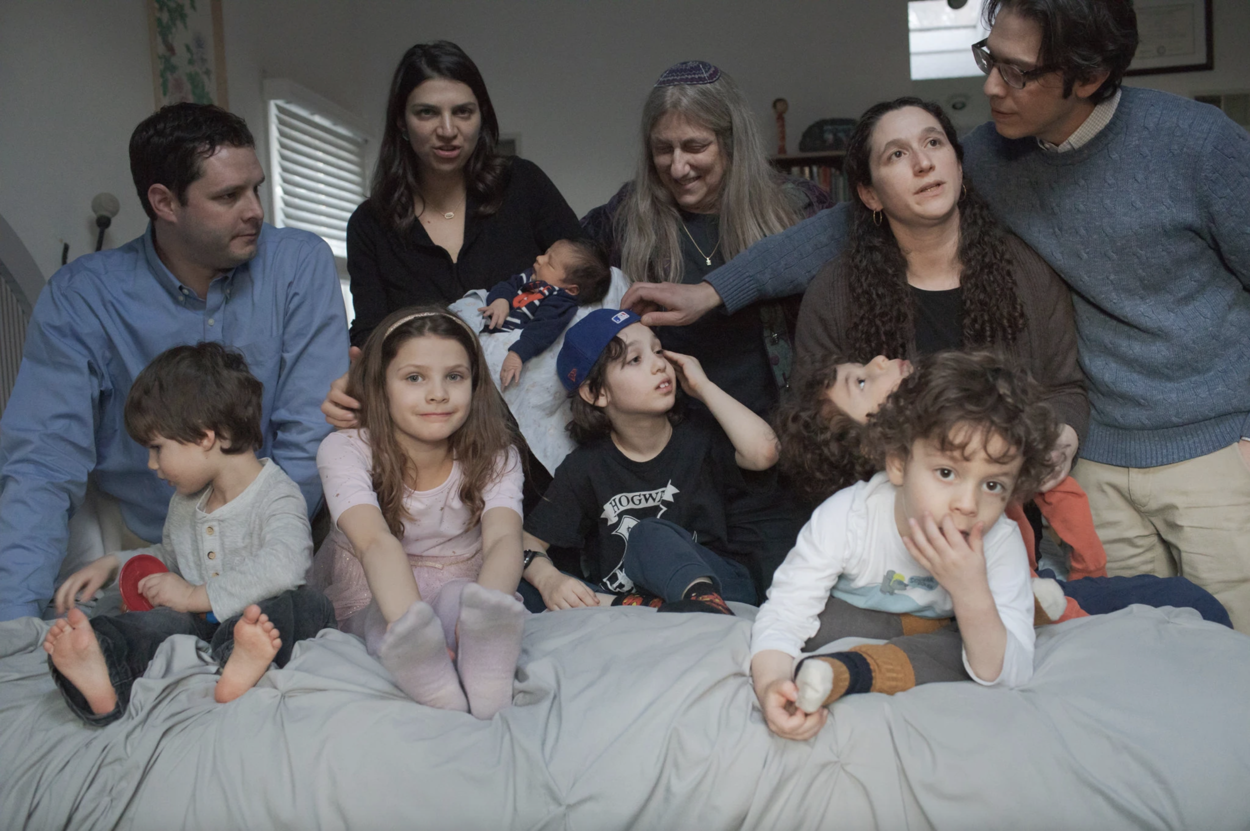 Emily Blake, mohel, with children she has performed bris for.png