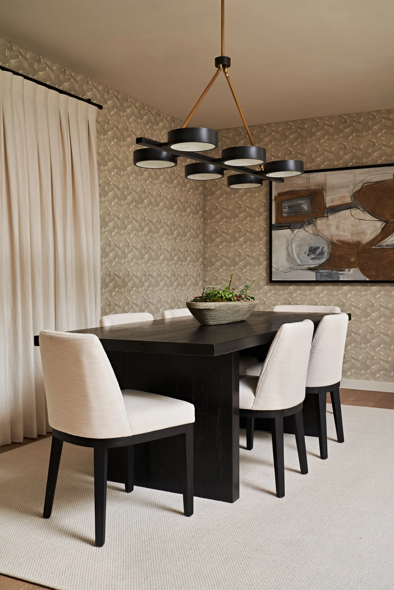 Modern black ebonized plinth dining table with Arteriors chandelier and curated art in Studio City, Los Angeles residential design. Top 5 interior designers in Los Angeles.