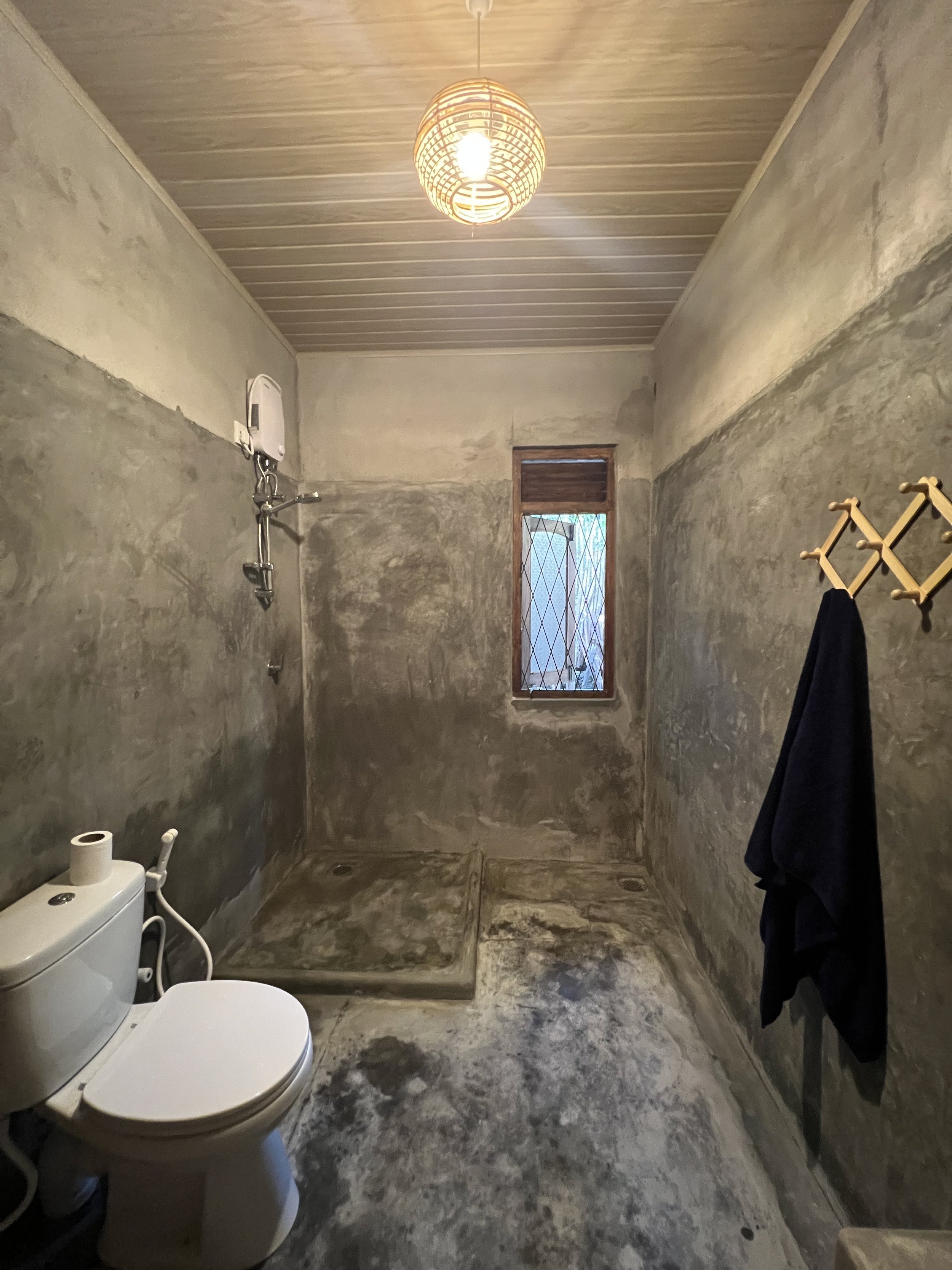 bathroom concrete and wood for into the blue's beach house, 20m from unakuruwa bay