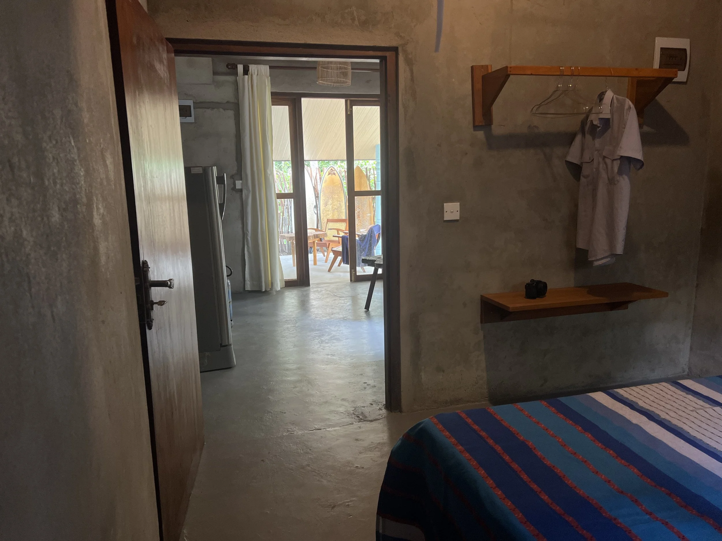 view from the bedroom to the living room and front terrace with garden