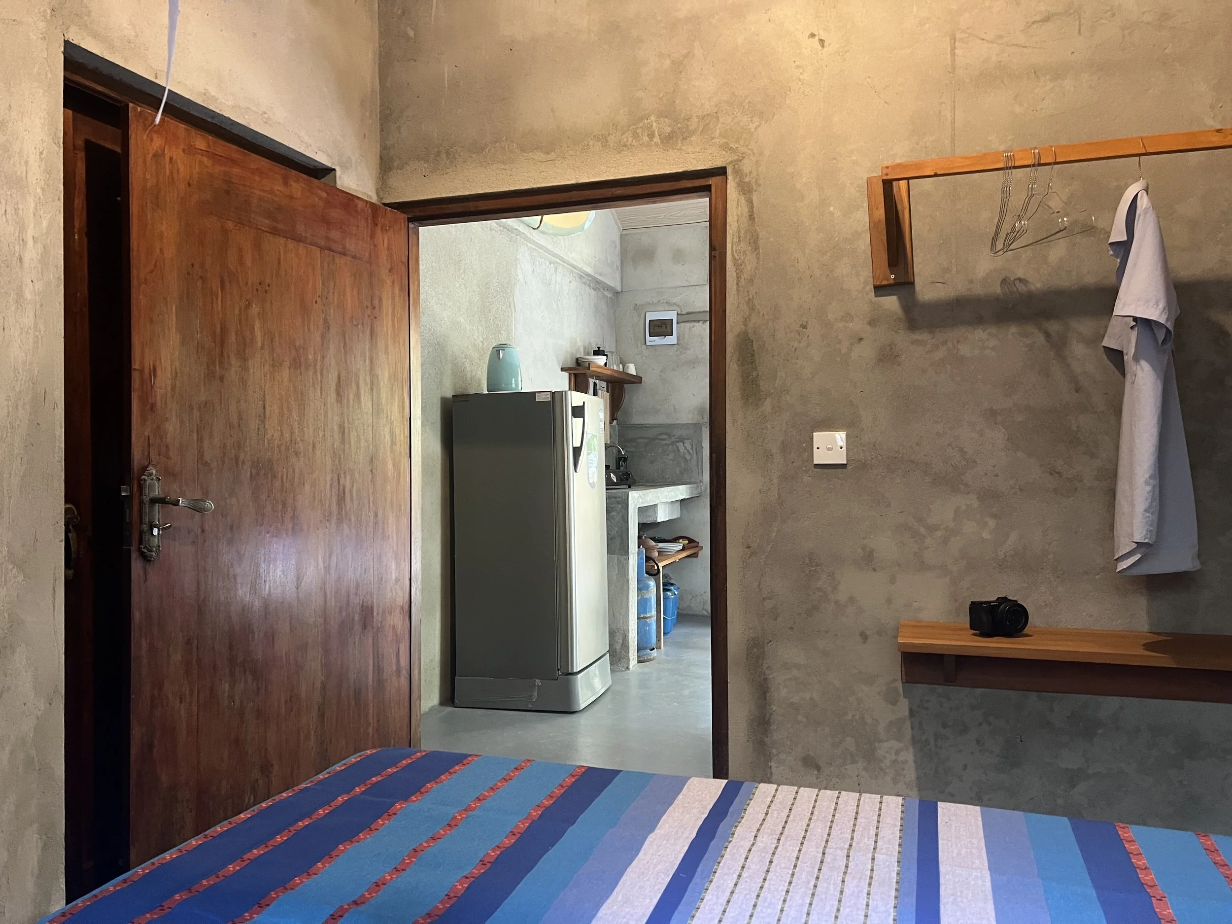 view from the bedroom to the kitchen and living room