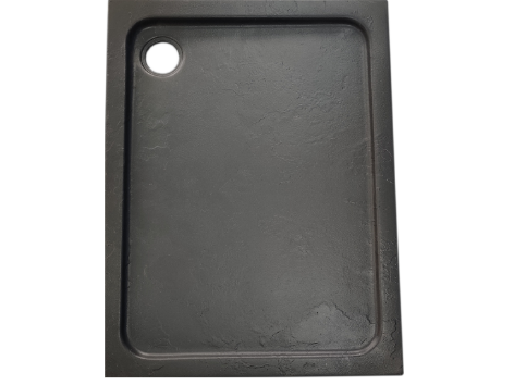 Black rectangular cutting board with a circular hole in the top left corner.