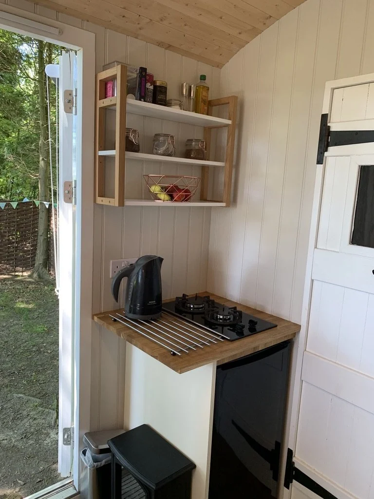Kitchenette with double gas stove, fridge & kettle.