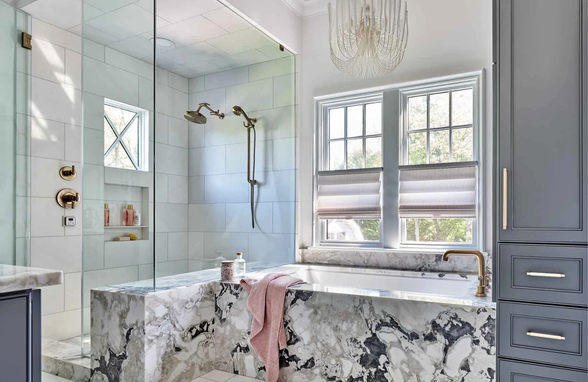 susan-hill-design-group-gastonia-sc-natural-vs-engineered-stone-luxury-bathroom-stone-tub-blue-gray-cabinets-glass-shower-fresh-custom-home.jpg