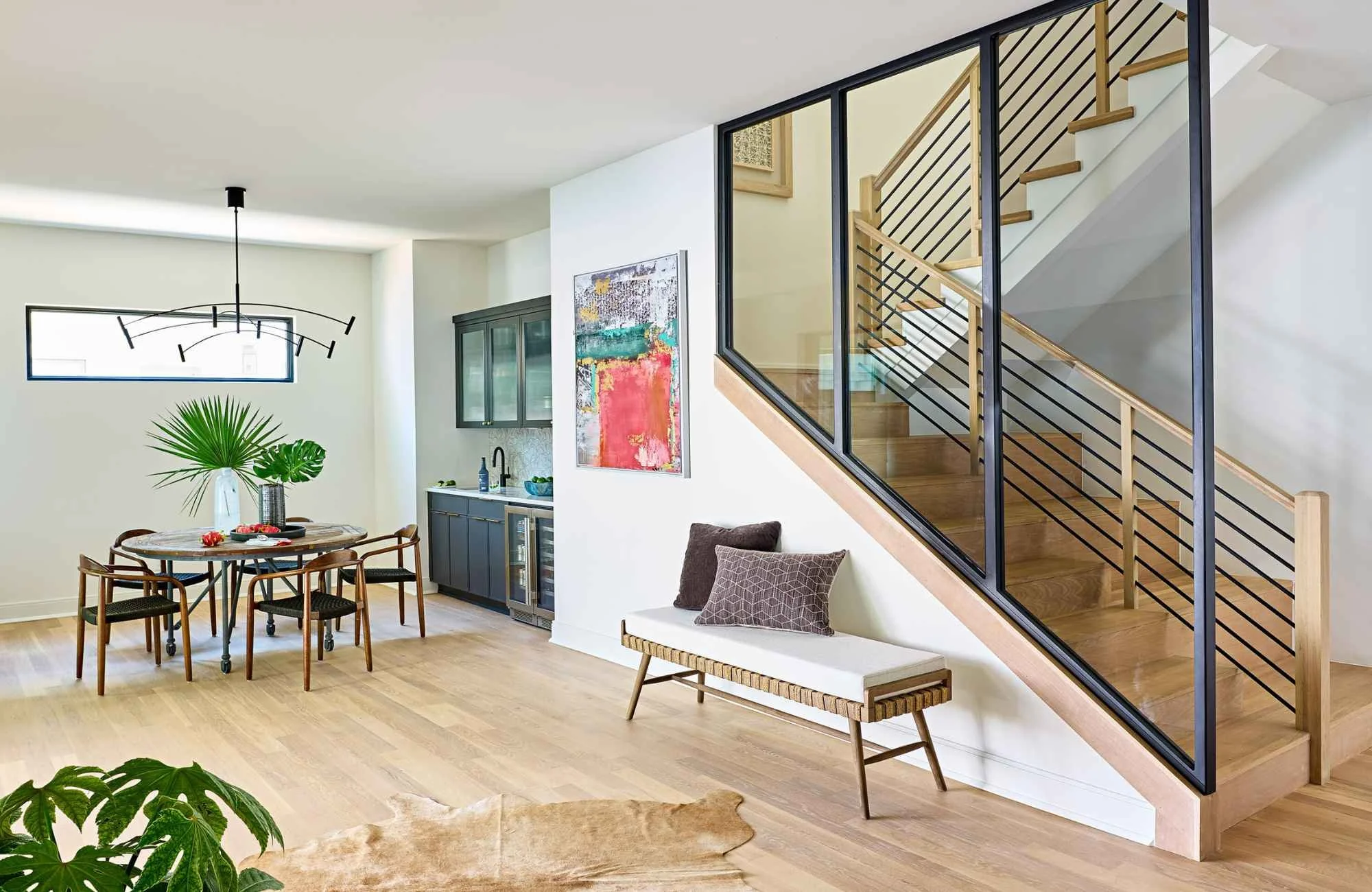 susan-hill-design-group-waxhaw-nc-texture-in-neutral-interiors-staircase-with-glass-wall-dining-area-light-wood-floors-connection.jpg