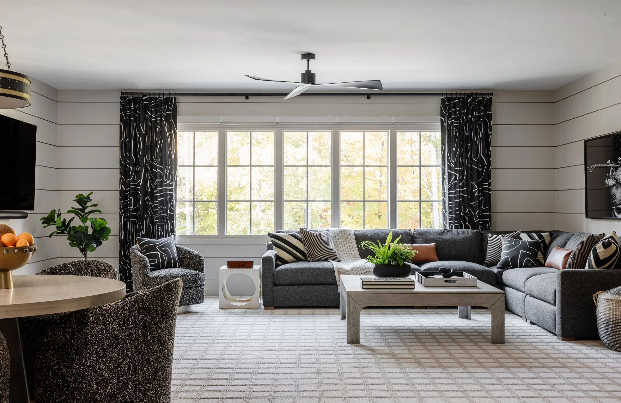 full-service-interior-design-tega-cay-sc-non-matching-cohesive-home-design-living-room-shiplap-walls-large-window-high-contrast-furnishings.jpg