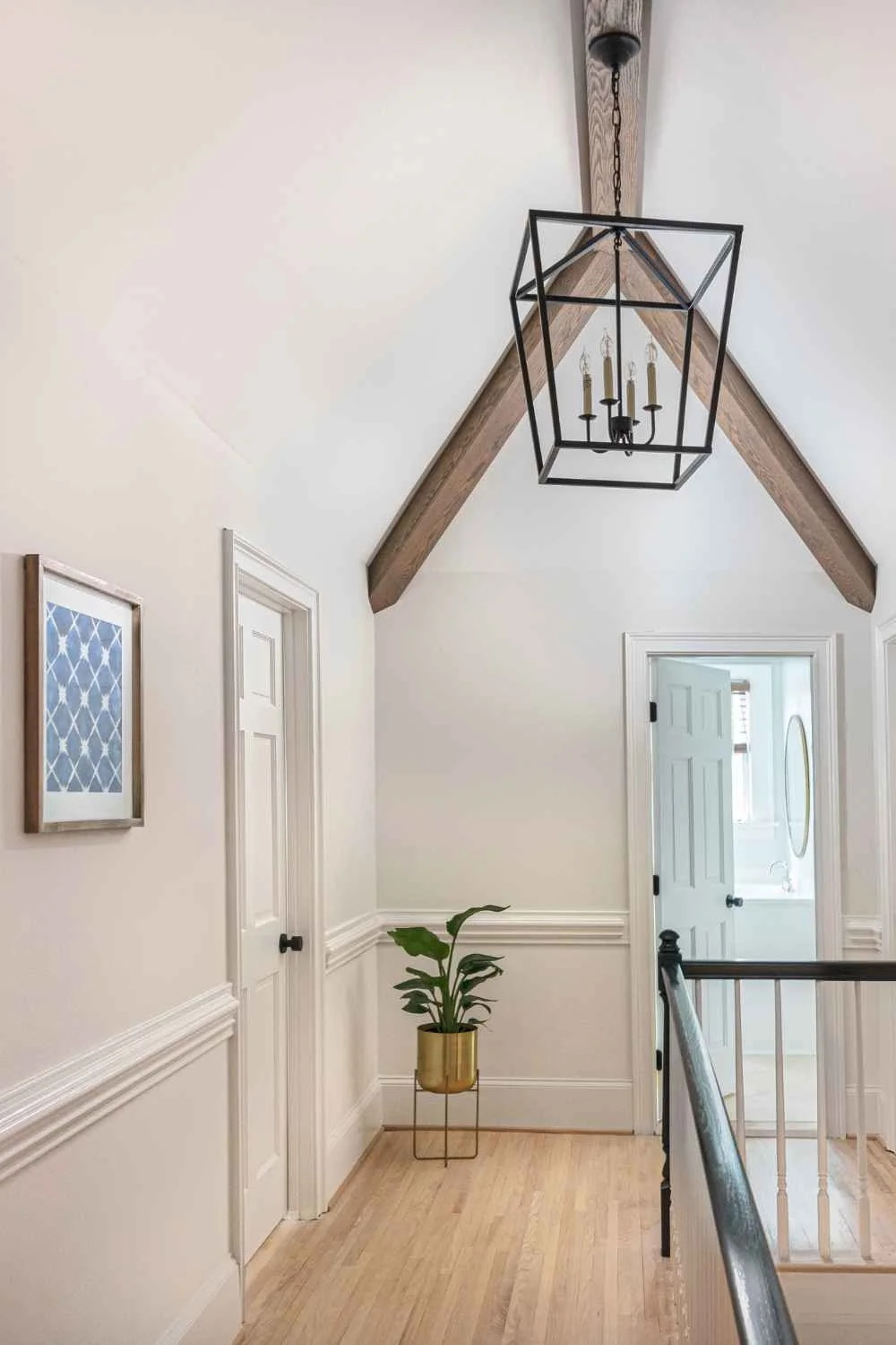 susan-hill-design-group-wesley-chapel-nc-wood-accents-in-home-upstairs-hallway-with-wood-beams-on-vaulted-ceiling-transforming-new-build.jpg