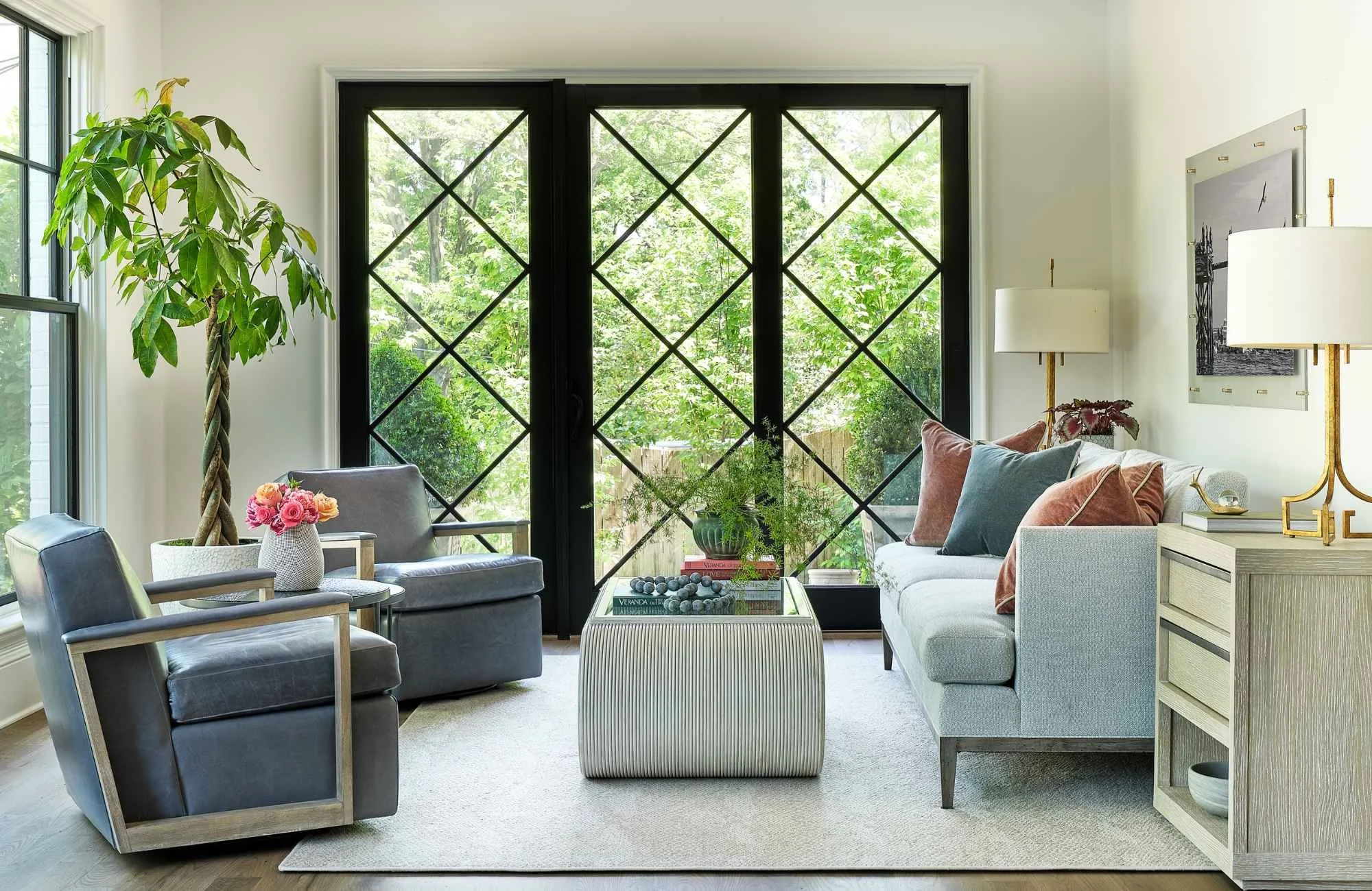 full-service-interior-design-ballantyne-nc-summer-home-refresh-sunroom-with-large-three-panel-door-to-outside-potted-plant-custom-sofa-and-chairs-connection.jpg