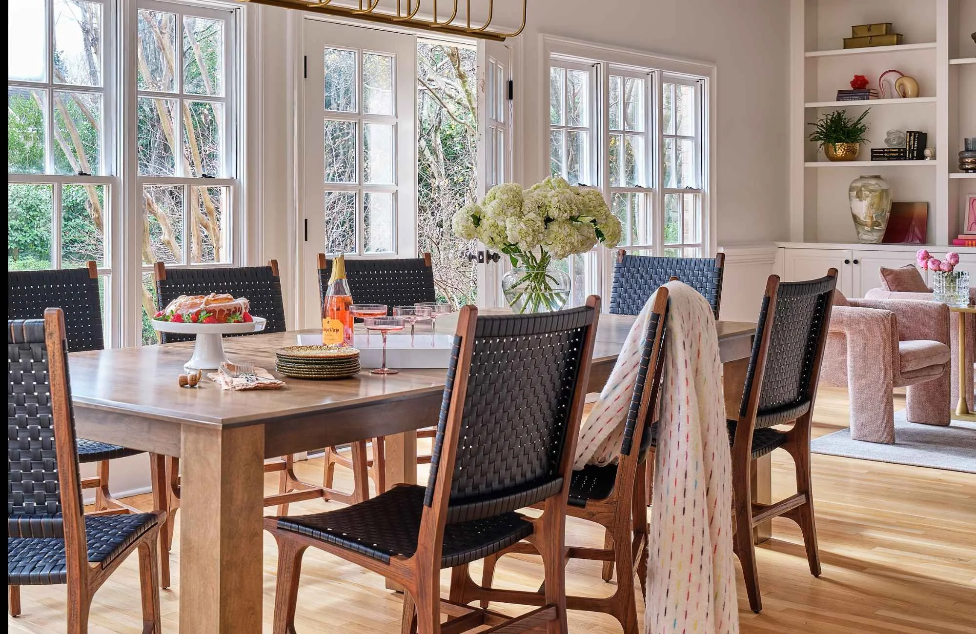 susan-hill-design-group-weddington-nc-interior-design-misconceptions-dining-table-by-wall-of-windows-comfortable-chairs-connection-construction-management.jpg