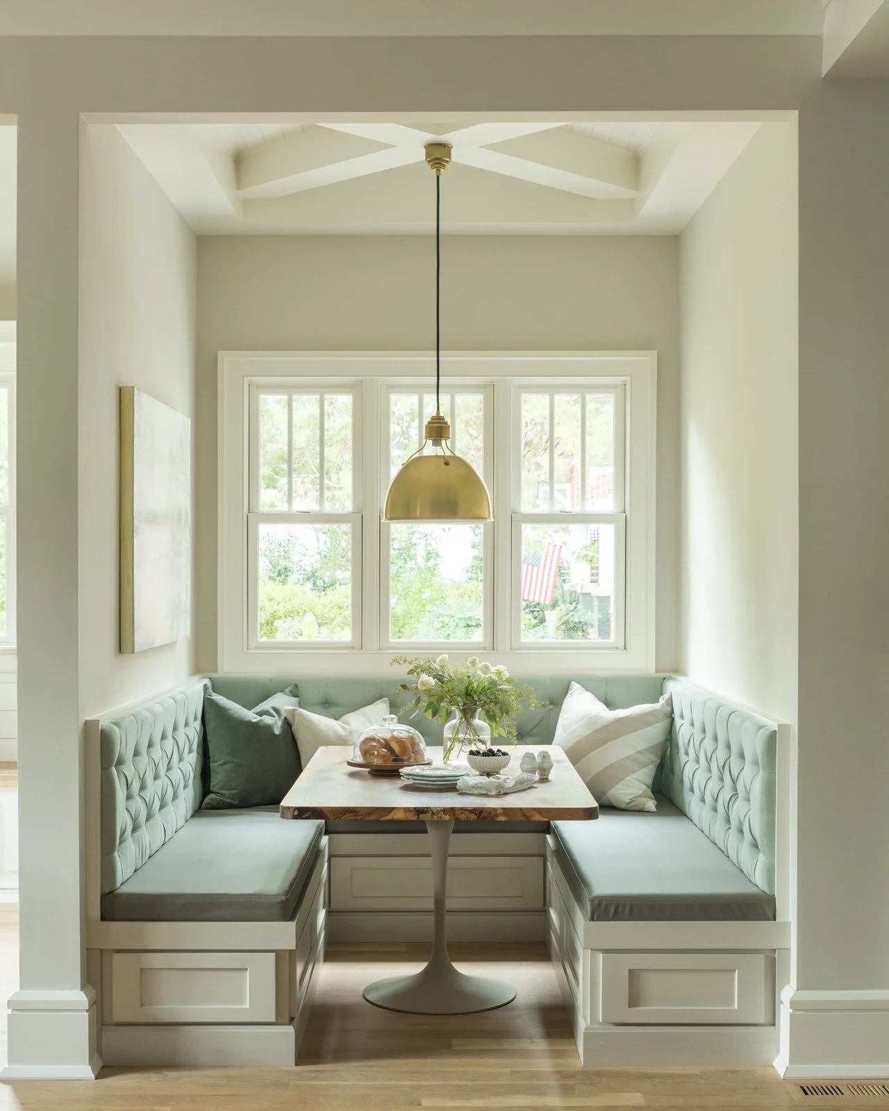 susan-hill-design-group-weddington-nc-roles-for-building-custom-home-built-in-dining-nook-by-window-blue-upholstered-bench-turnkey-home-furnishings.jpg