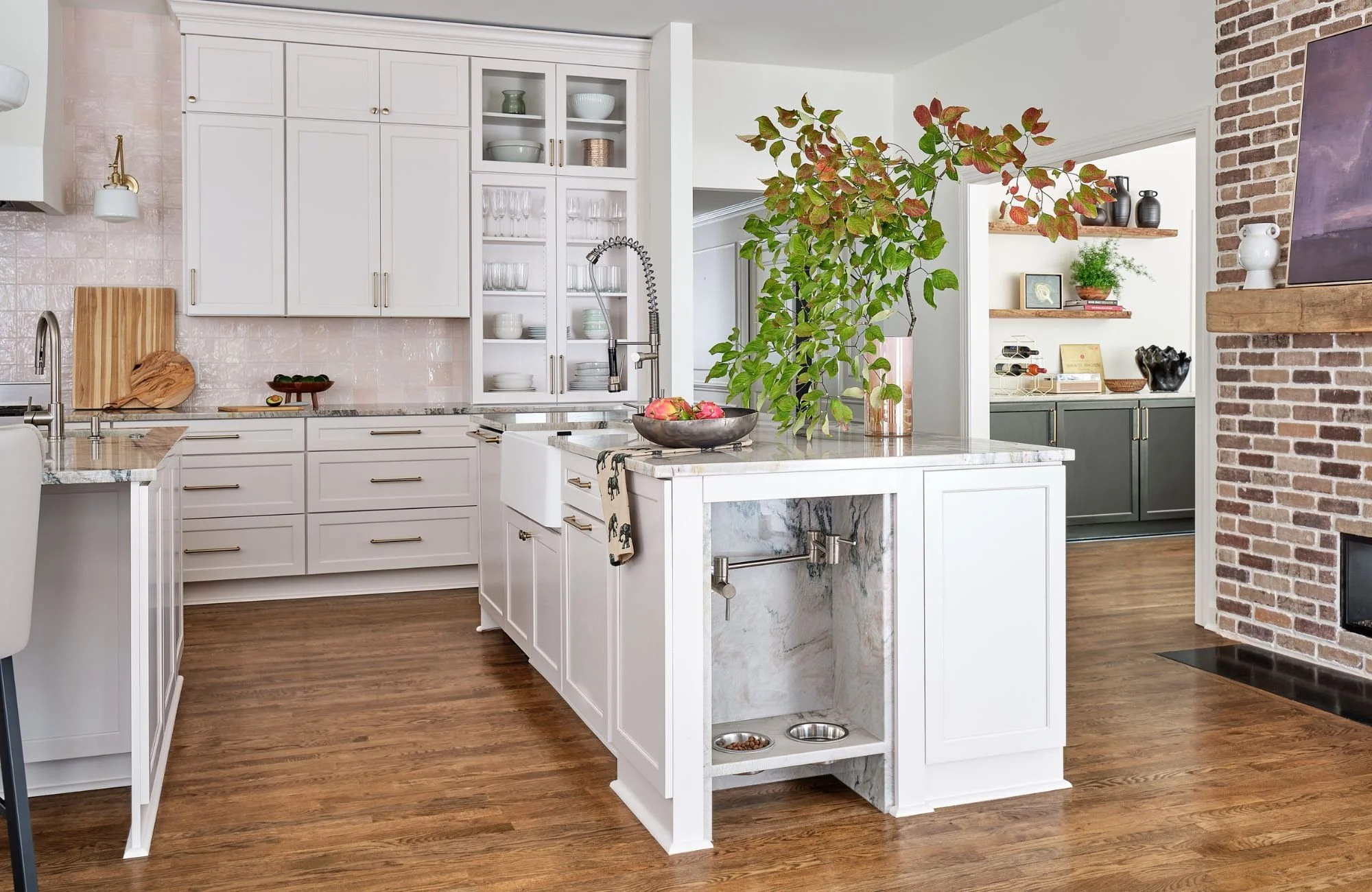 susan-hill-design-group-weddington-nc-non-matching-cohesive-home-design-kitchen-with-white-cabinets-island-brick-fireplace-separating-living.jpg