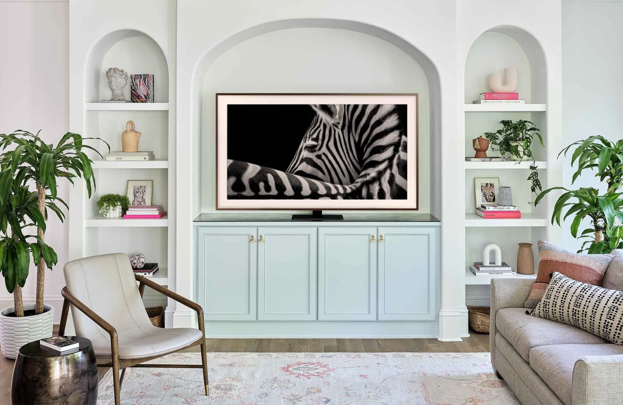 full-service-interior-design-huntersville-nc-summer-home-refresh-living-room-built-in-arched-cabinets-painted-in-soft-blue-potted-plants-bright-new-build.jpg