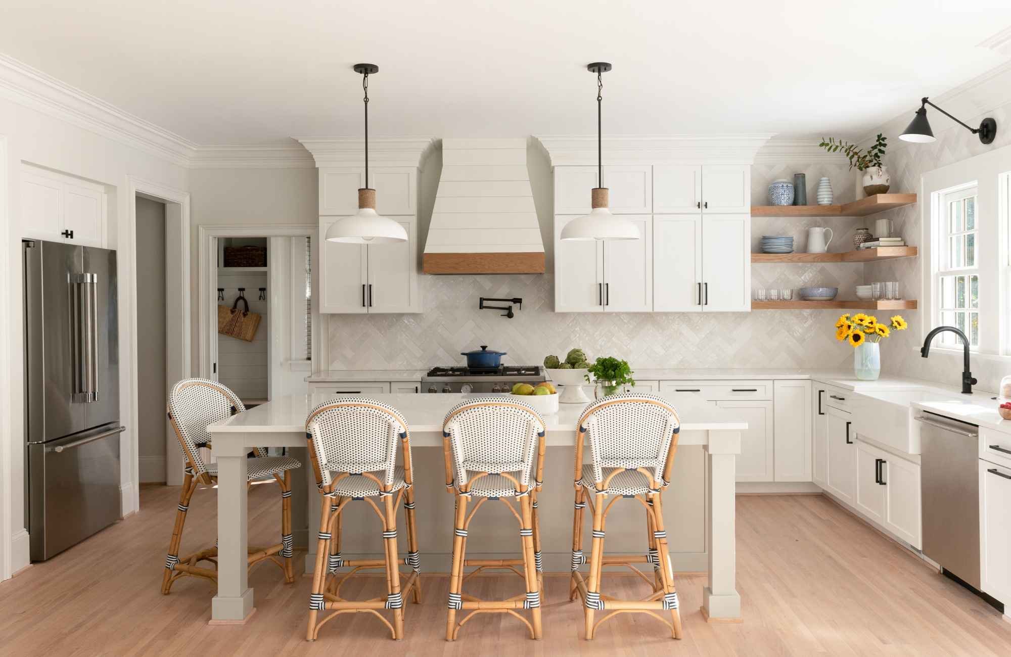 full-service-interior-design-tega-cay-sc-renovation-timeline-home-kitchen-with-island-and-bar-stools-custom-range-hood-wood-floor-connection.jpg