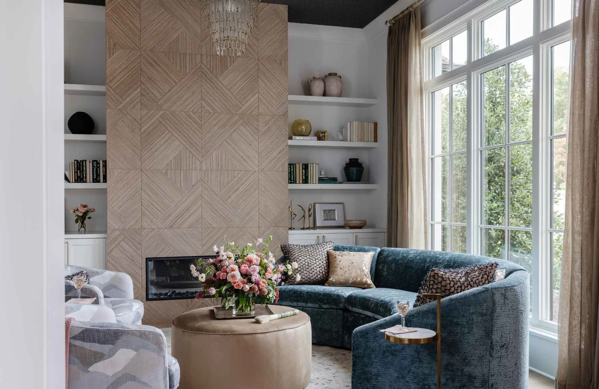 full-service-interior-design-wesley-chapel-nc-open-vs-closed-floor-plan-comfortable-living-room-curved-blue-sofa-floor-to-ceiling-windows-family-life.jpg