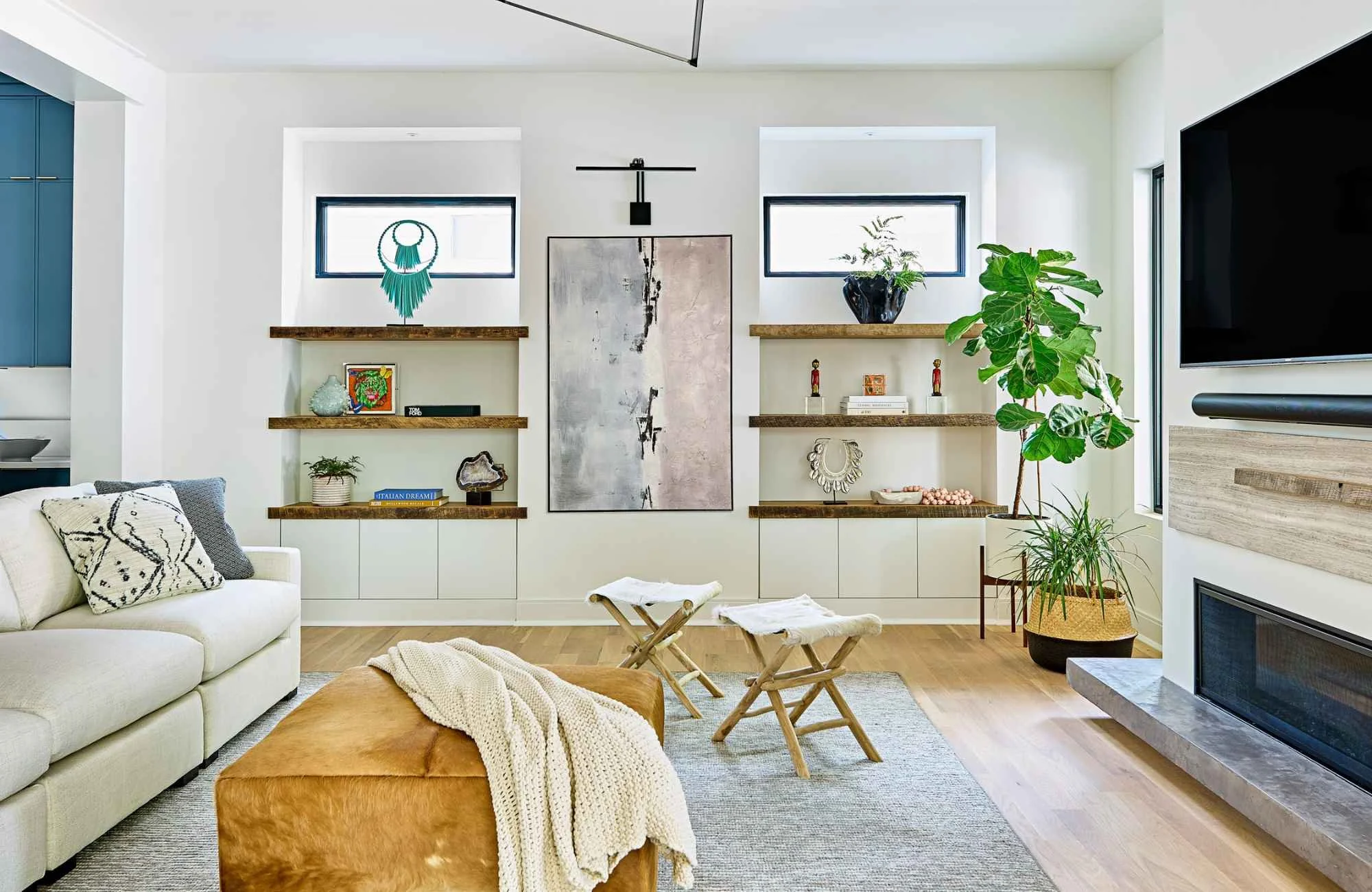 susan-hill-design-group-matthews-nc-texture-in-neutral-interiors-living-room-with-modern-accents-shelvs-under-windows-modern-fireplace-comfort.jpg